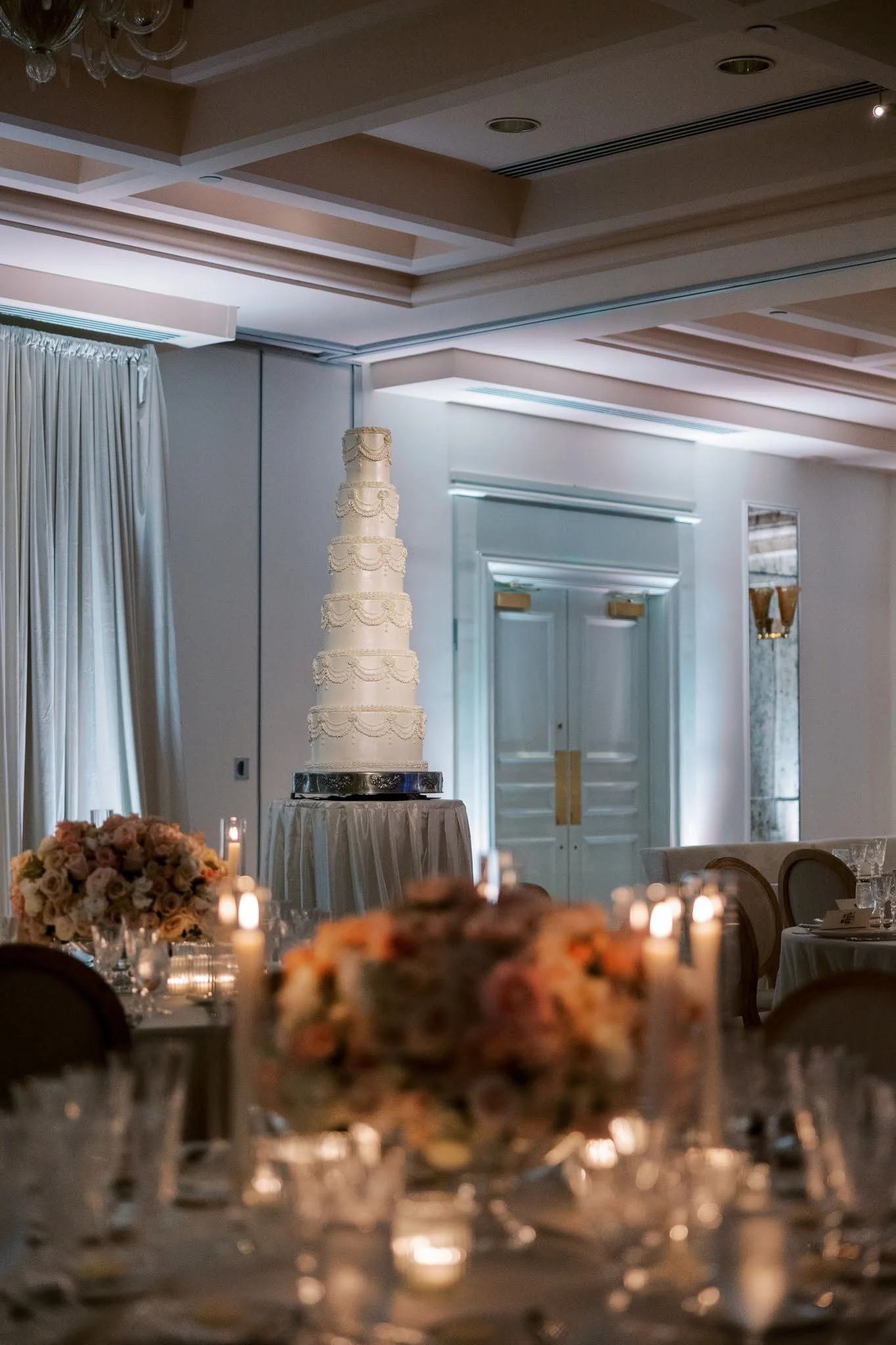 Tiered wedding cake against a blue-lit drape backdrop in Southwest Florida