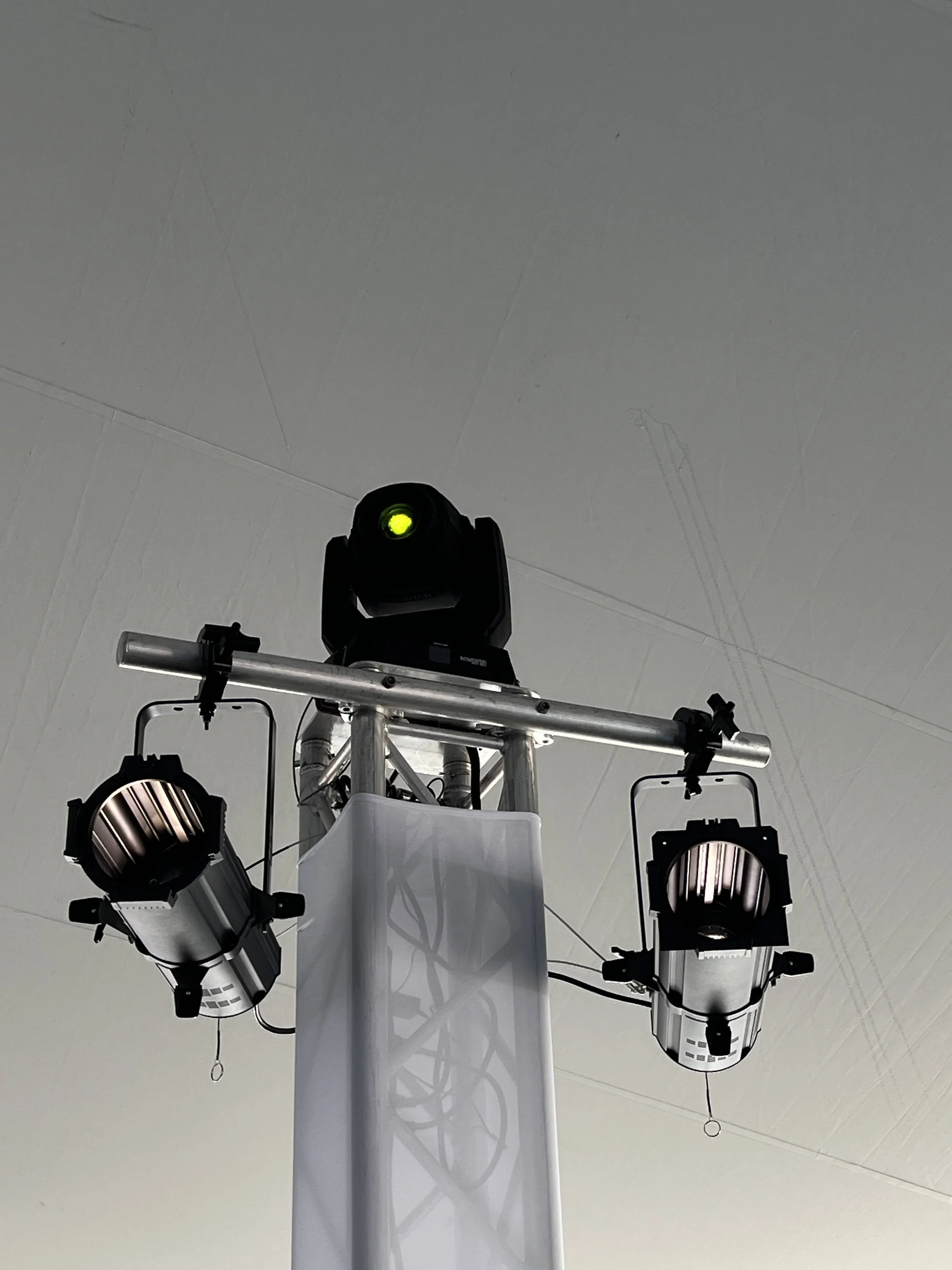 Close-up of a yellow moving head light mounted on truss in Sarasota