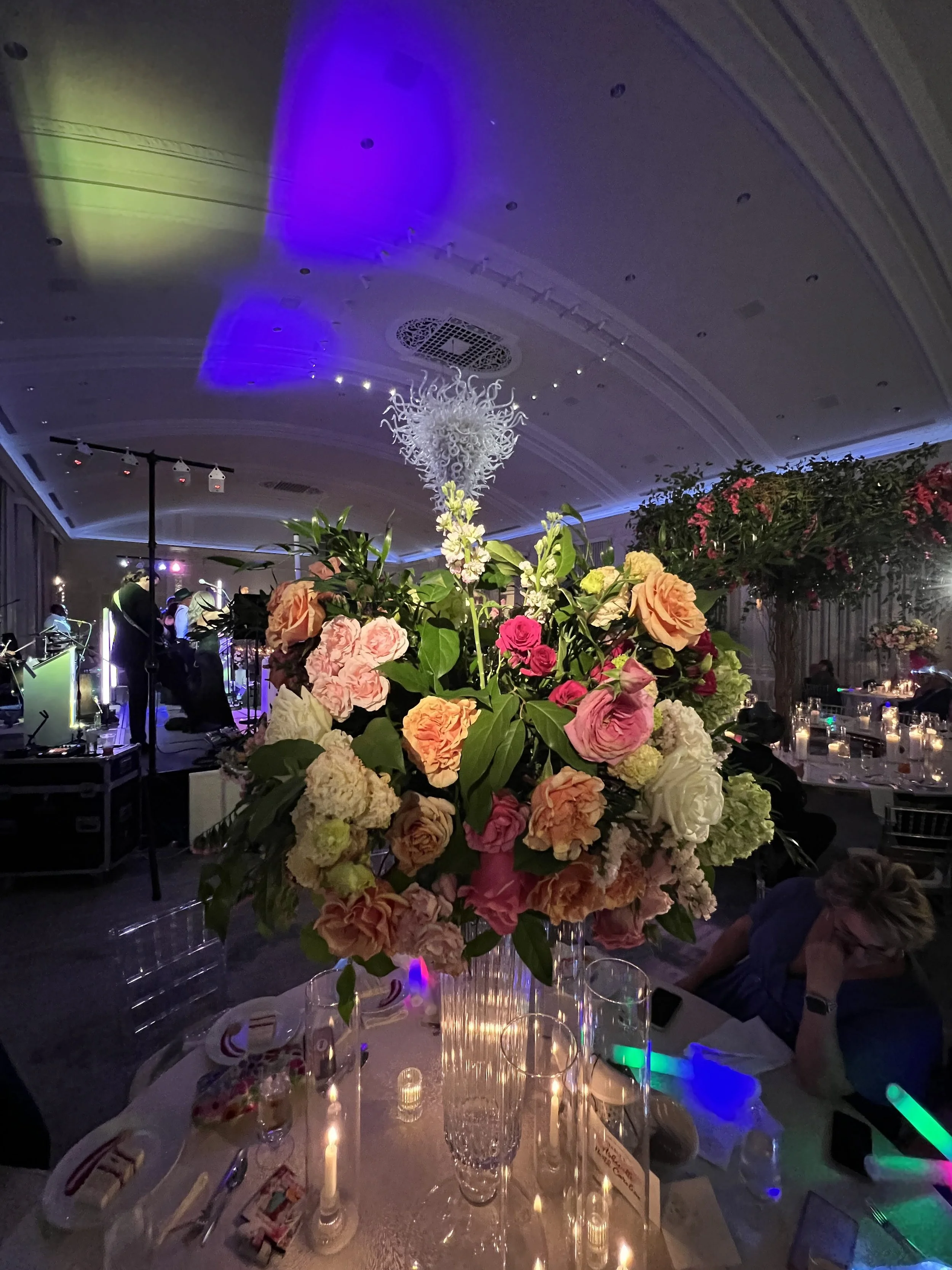 Live band performing with large floral arrangement in the foreground in Southwest Florida