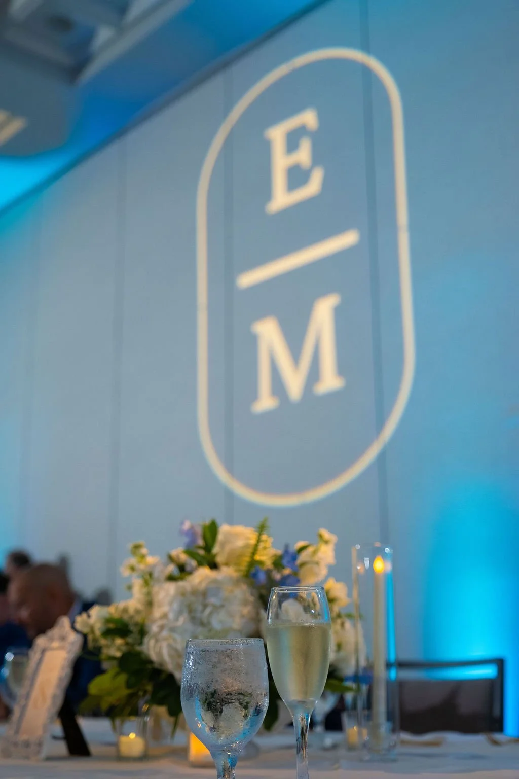 Close-up of custom monogram gobo projection on a blue wall in Sarasota