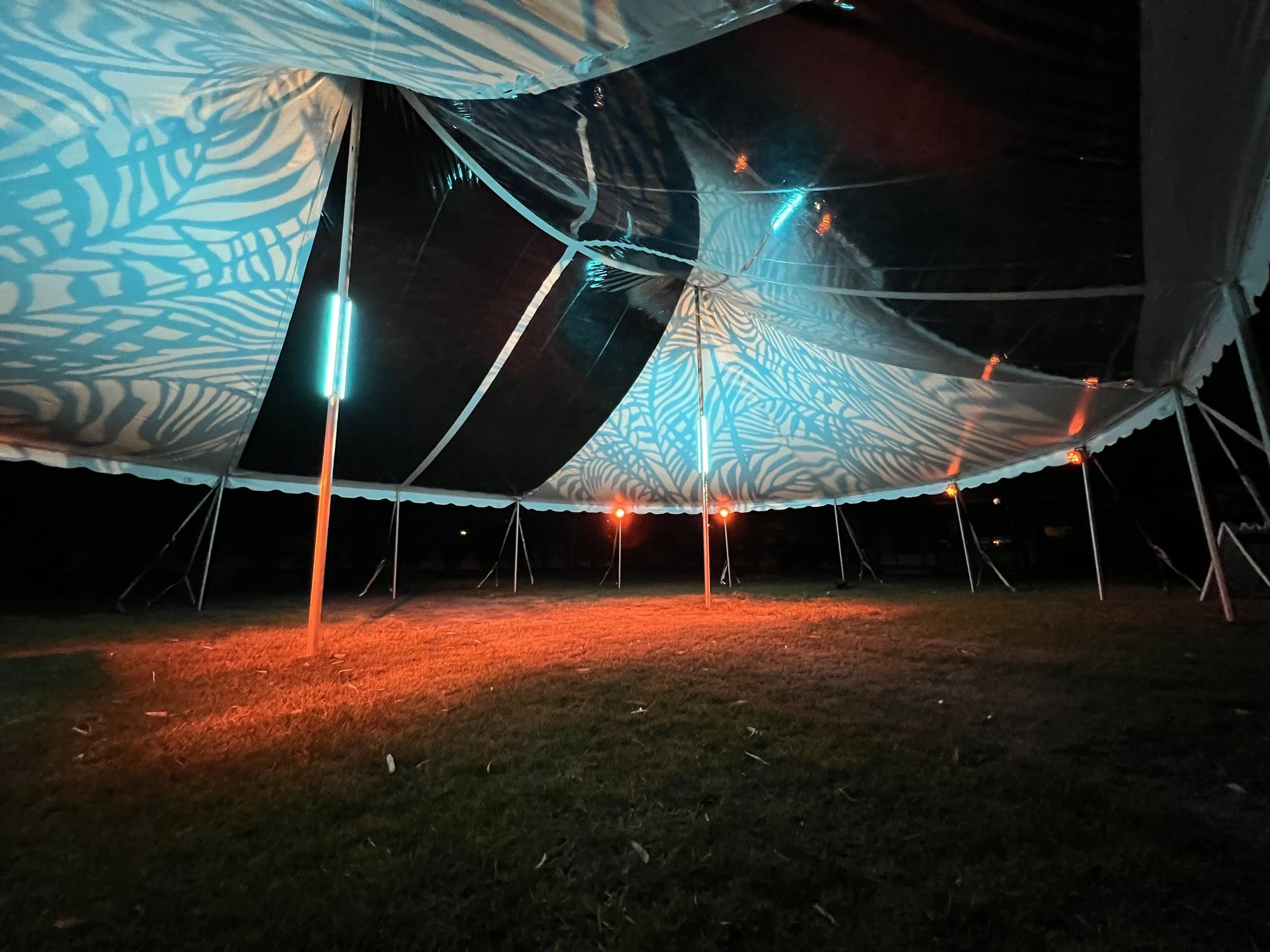 Tent interior with blue pattern lighting and orange ground lighting in Sarasota