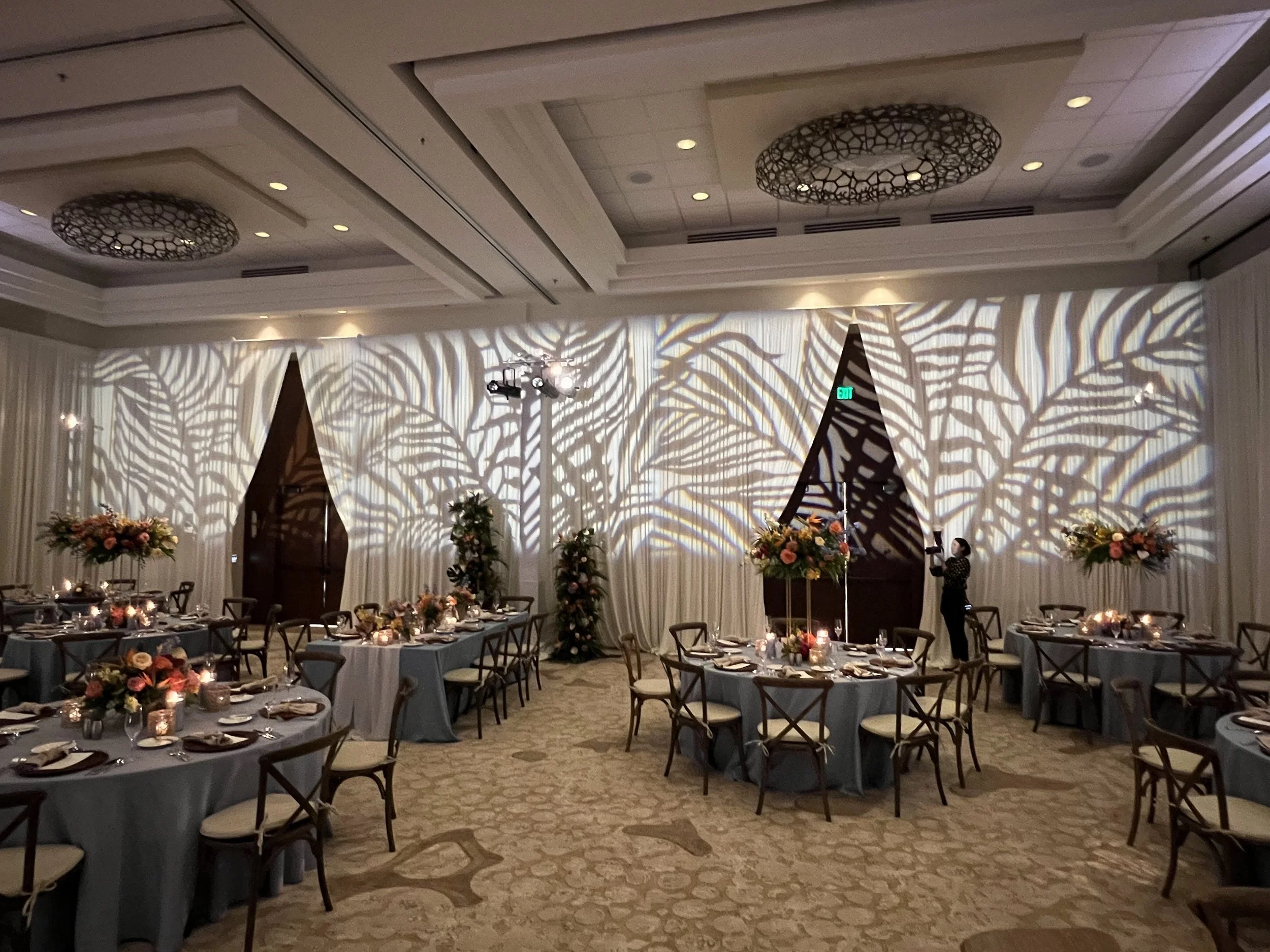 Palm leaf pattern gobo projection on ballroom walls in Sarasota