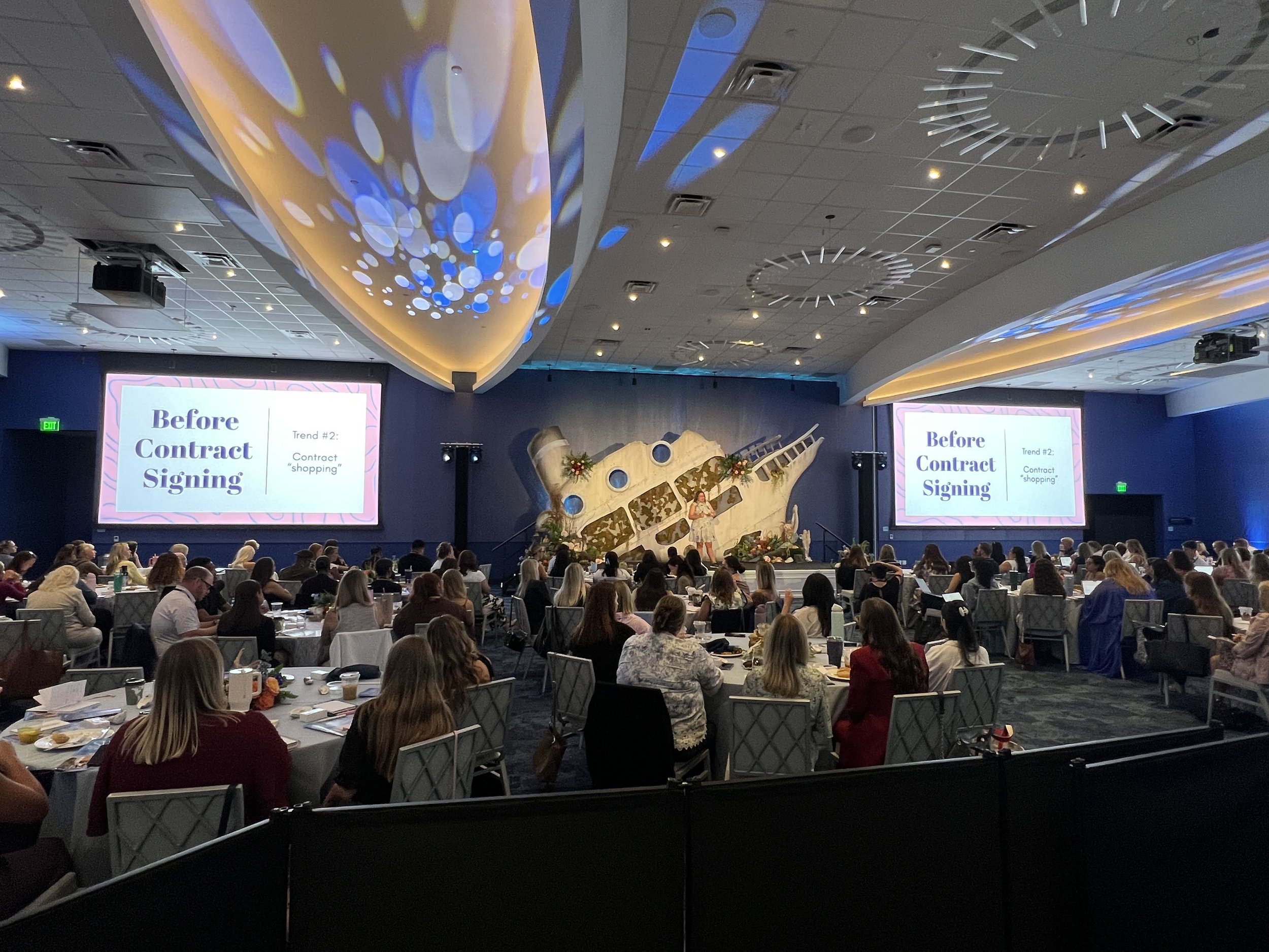 Dual presentation screens and custom stage backdrop at a corporate conference in Sarasota