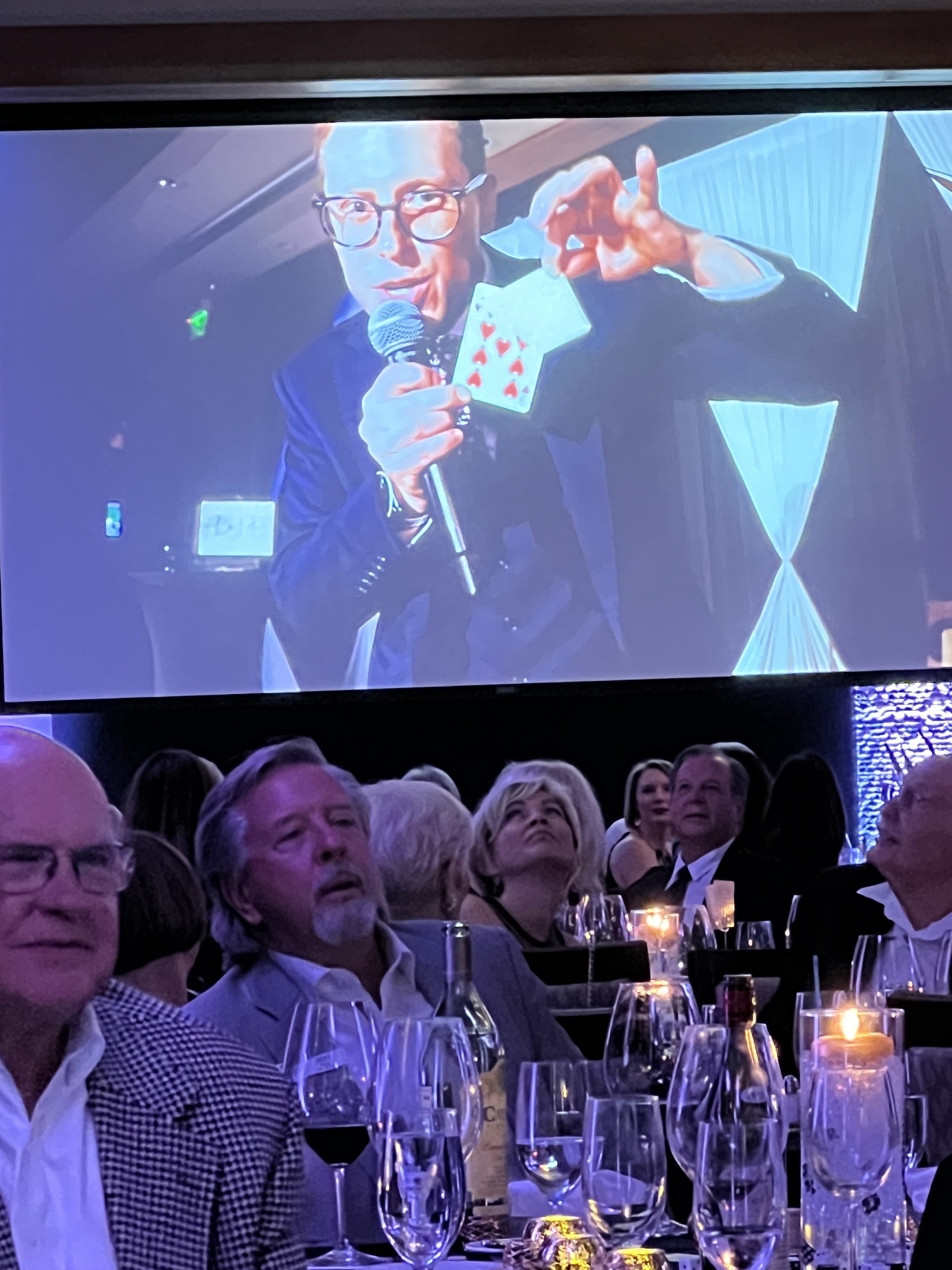 Large screen presentation with live performer visuals for a corporate audience in Southwest Florida