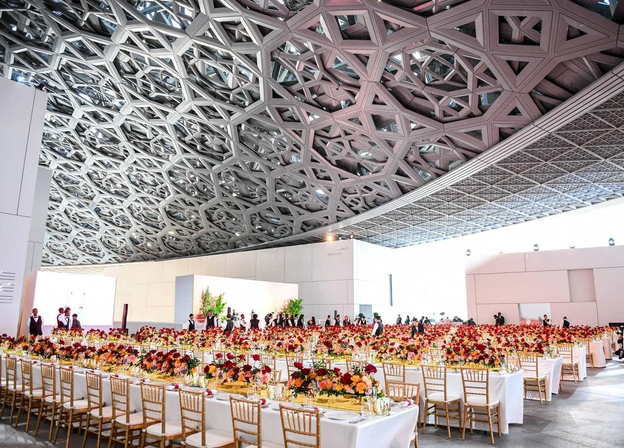 Gala dinner tables set beneath the latticed dome of the Louvre Abu Dhabi during the Forbes 30/50 Summit