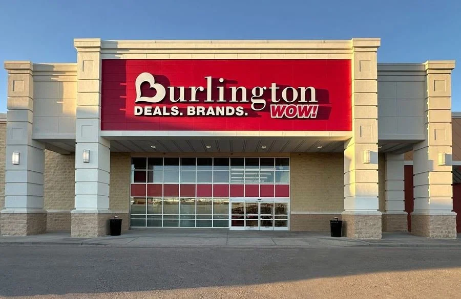 Exterior of Burlington store with a large red sign displaying the store's name and promotional messages.
