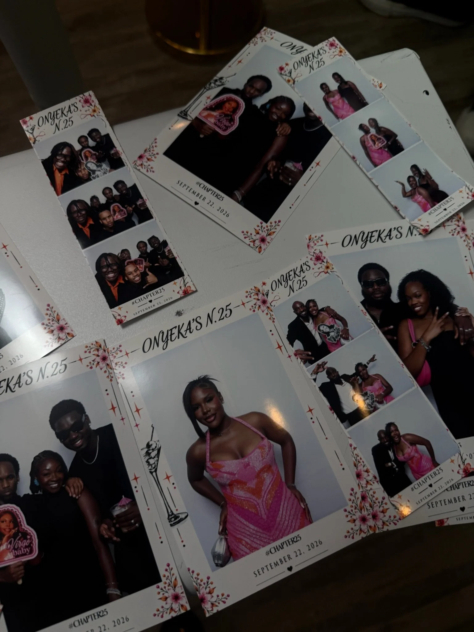 Multiple photo booth strips featuring a woman in a pink dress and several group photos of people at a celebration. Text on the strips reads "Onyeka's N.25," "#Chapter25," and "September 22, 2026," with floral decorations around the borders.
