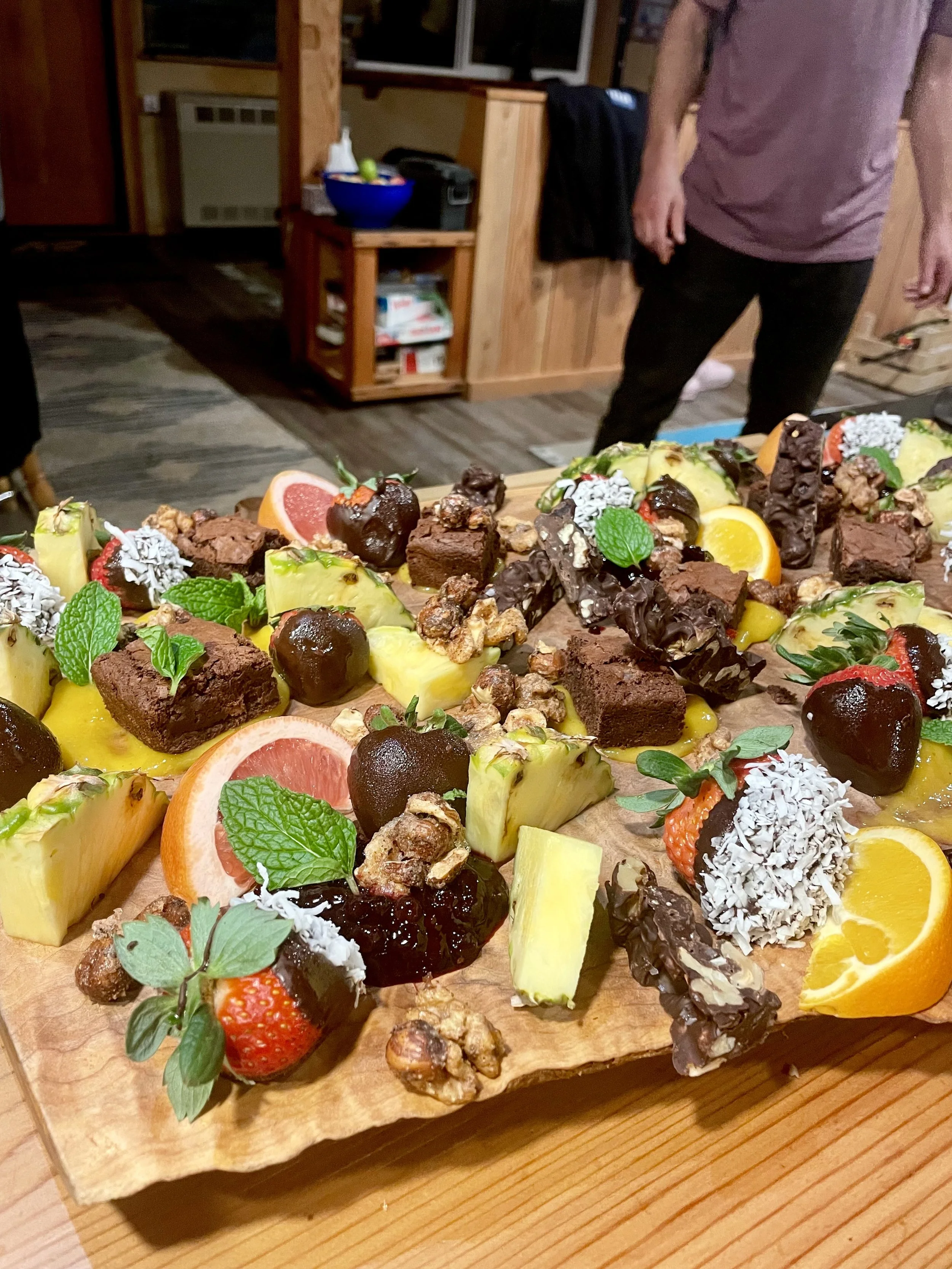 Dessert and fruit grazing board with chocolate-dipped strawberries and citrus, Revelstoke event catering.