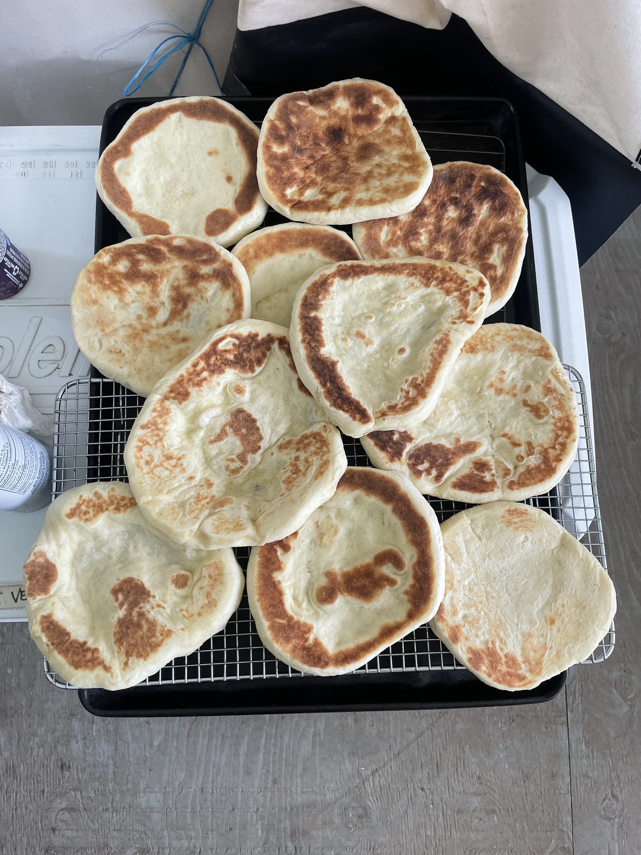Freshly cooked flatbreads cooling on a rack, house-made by a private chef for a Revelstoke lodge stay.