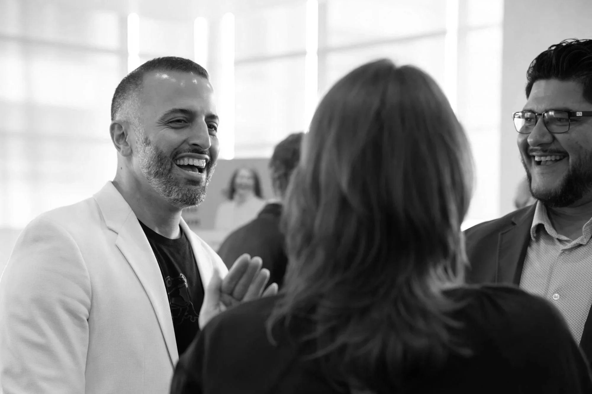 People smiling and talking at a professional networking event