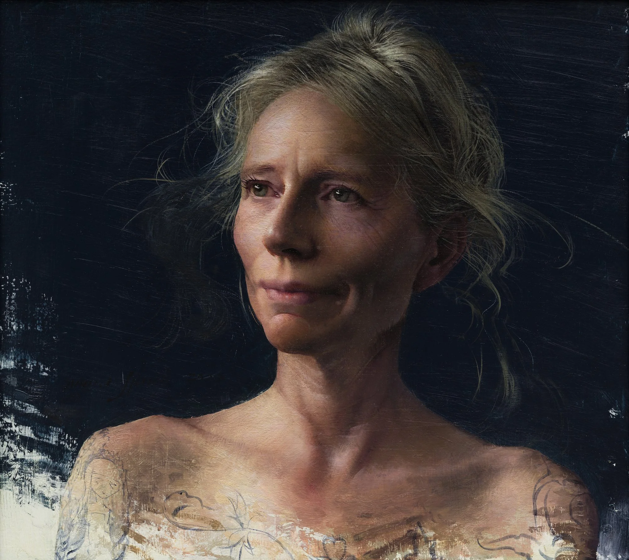 Close-up of a woman with gray hair, looking slightly upward, with textured and painted artistic background.