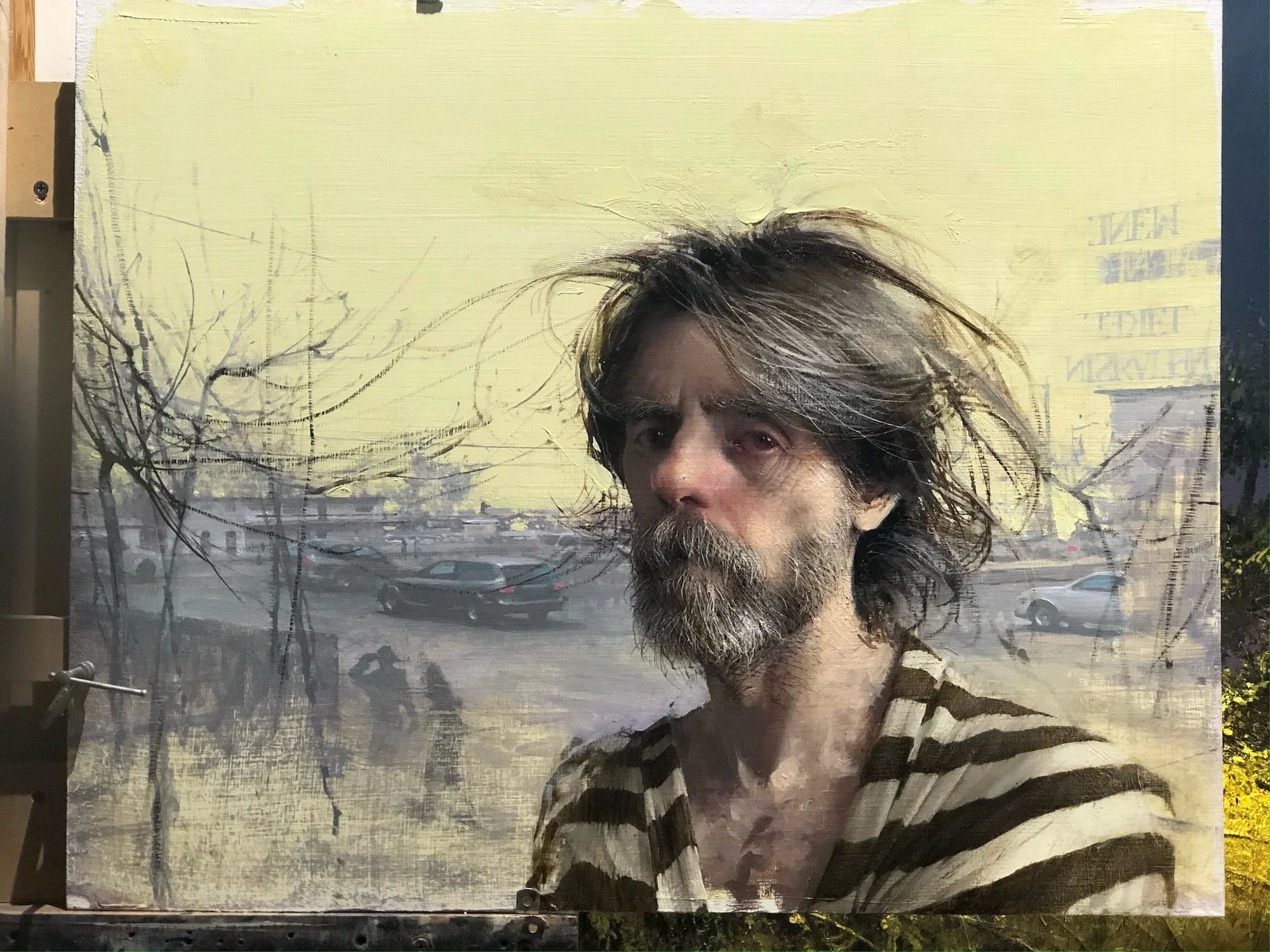 The Prophet Daniel with Writing on the Wall by Daniel Sprick. Portrait of a man with long, graying hair and a beard, wearing a striped shirt, standing outside in winter with bare trees and a brightly lit background sky.
