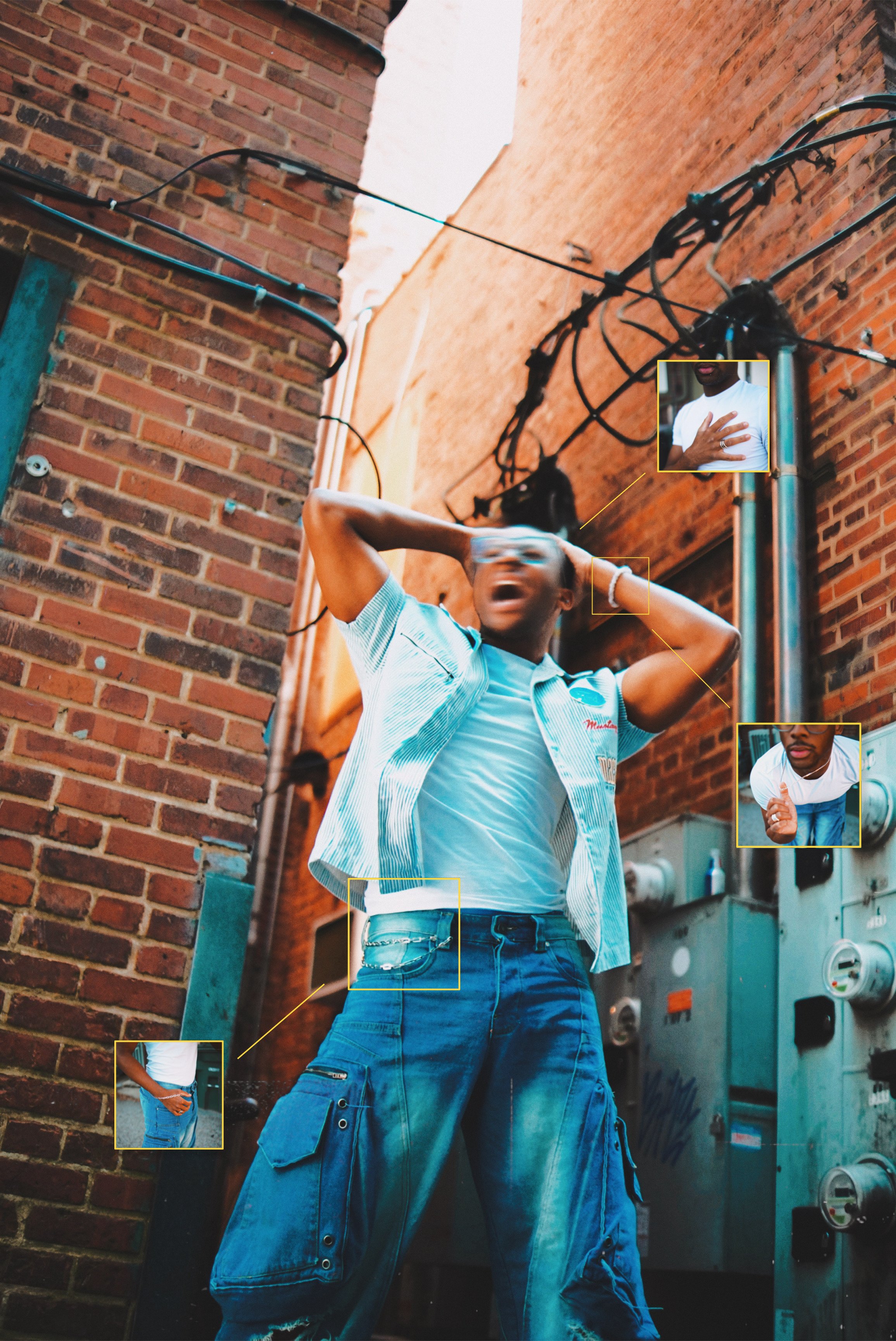 A person wearing a striped short-sleeve shirt and baggy blue jeans, standing in an outdoor alleyway with brick walls, with electrical wires overhead and utility boxes on the wall.