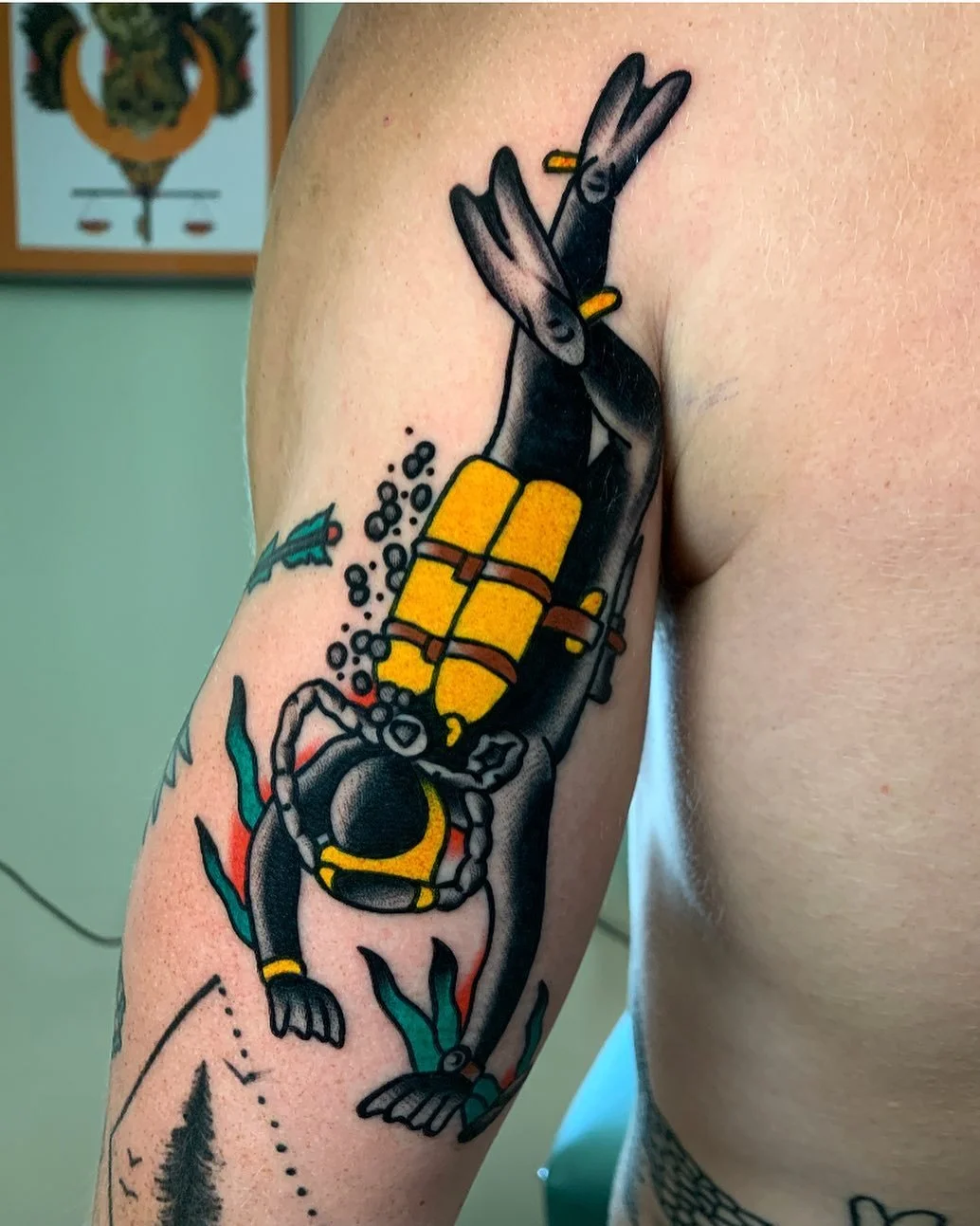 Tattoo of two rabbits with scuba diving gear, submerged underwater with bubbles and seaweed.