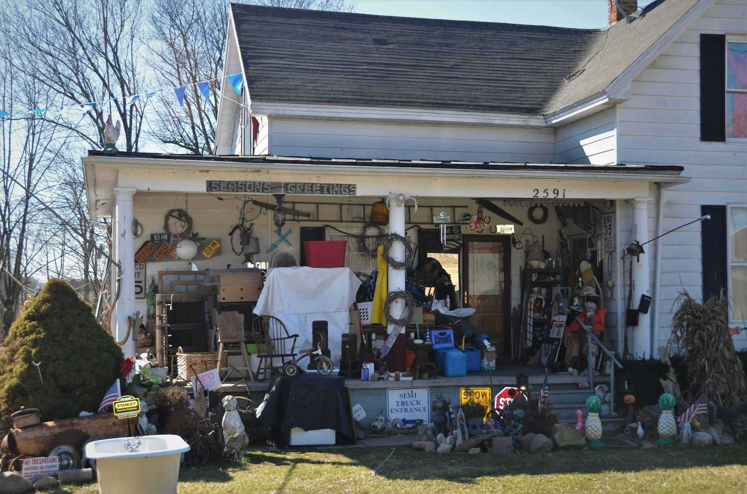 The front of a house used for a yard sale, with items displayed outside and in the porch located in North Myrtle Beach,  SC.