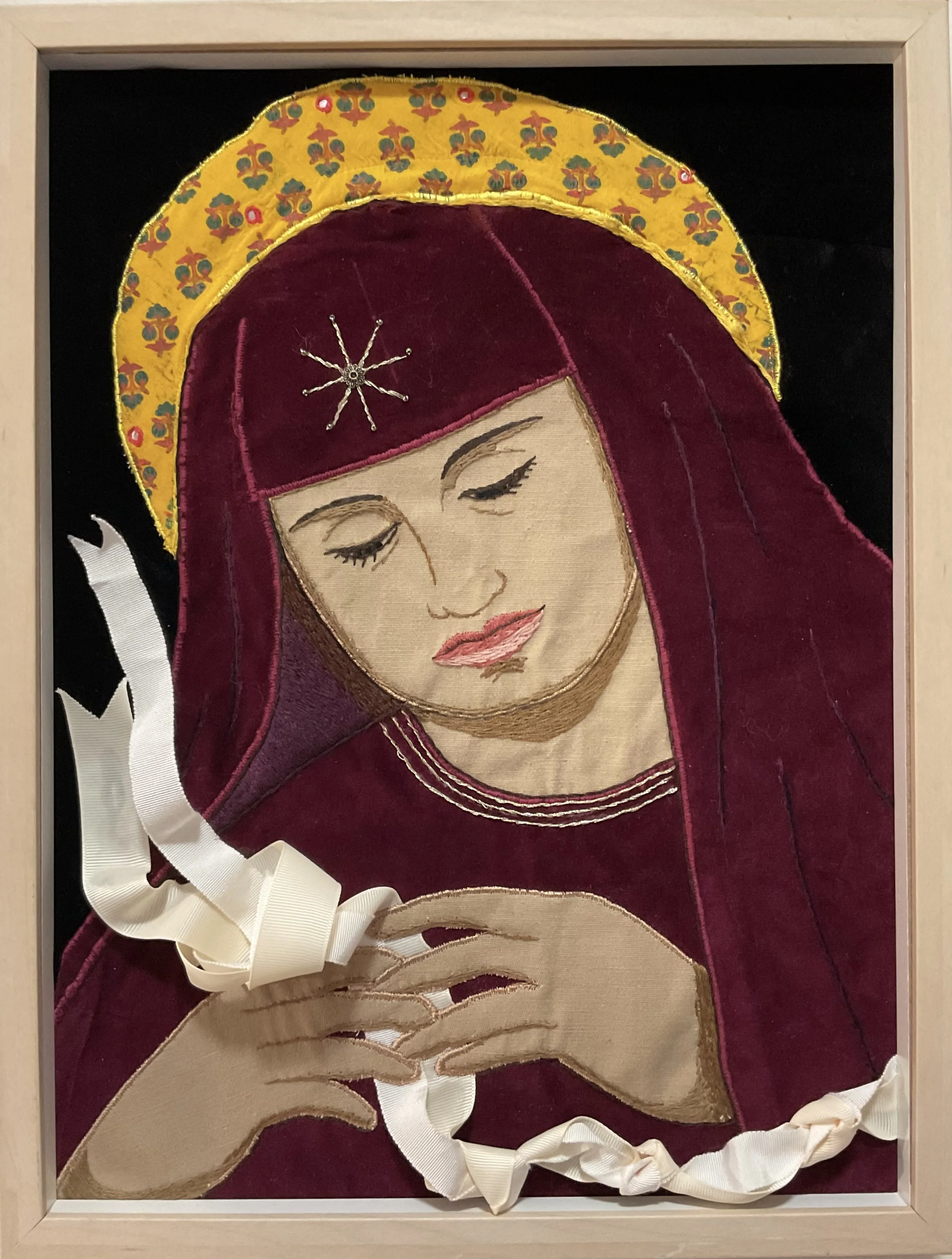 "Unknotting Mary" 2026, Recycled fabric, beads mounted on recycled frame.