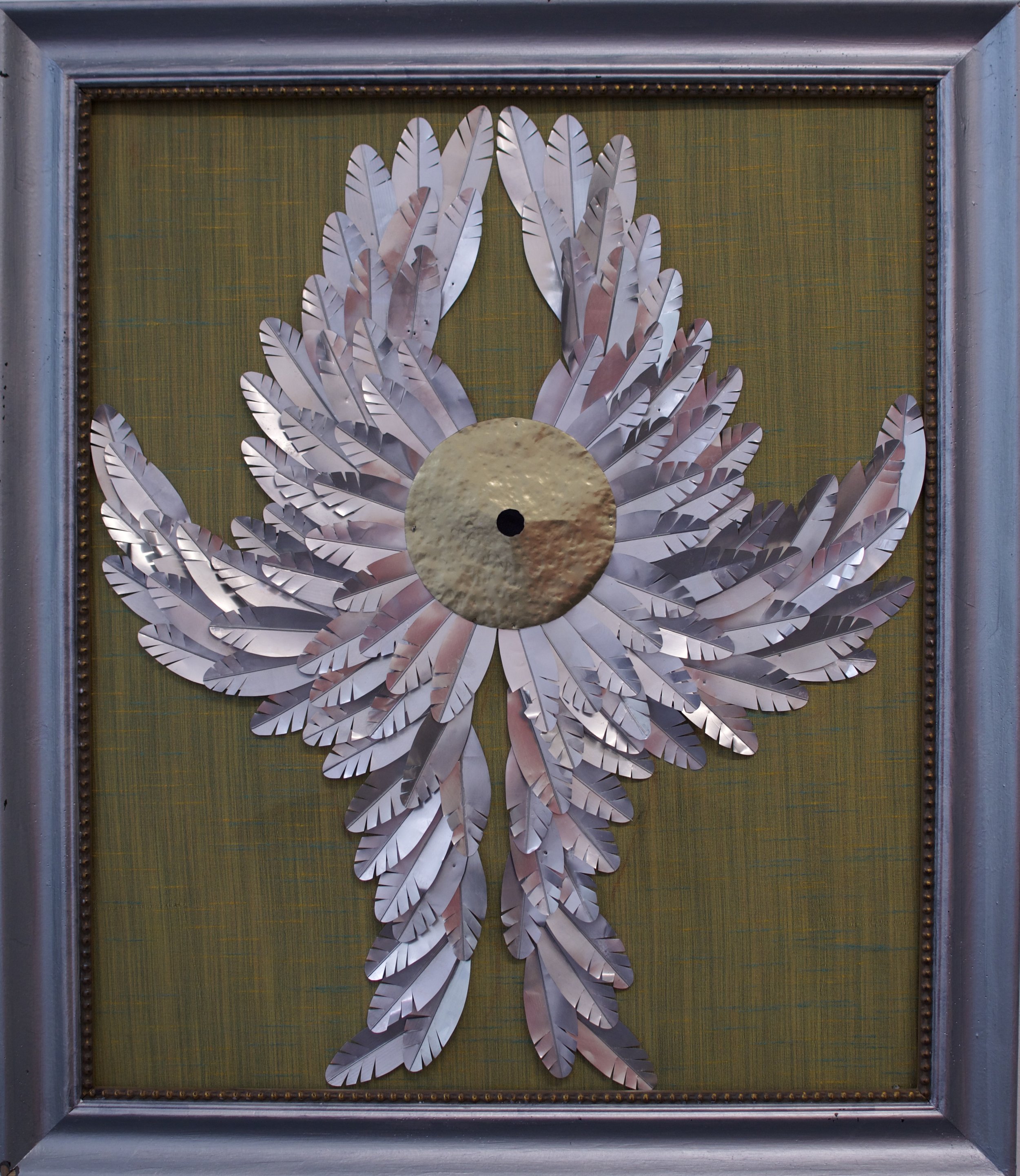 "Seraphim" 2025, 27" x 24", Aluminum cans, recycled fabric, tin mounted on recycled frame.