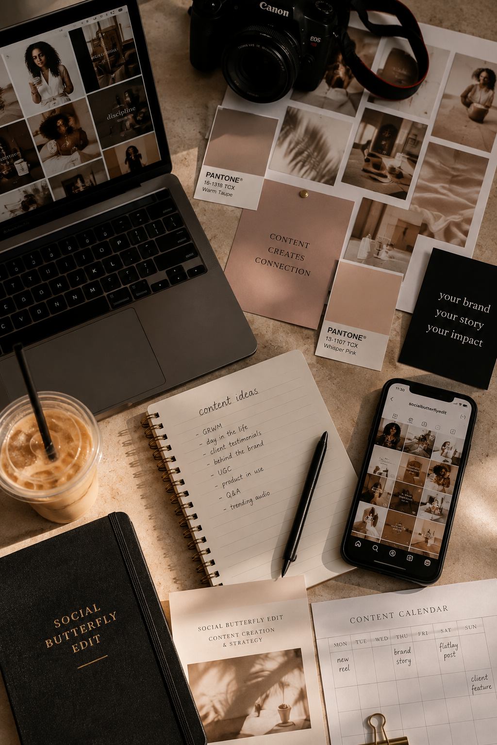An overhead view of a workspace with a laptop, a camera, printed photographs, a smartphone displaying an Instagram feed, a notepad with content ideas, color swatches, and various printed materials related to content creation and branding.
