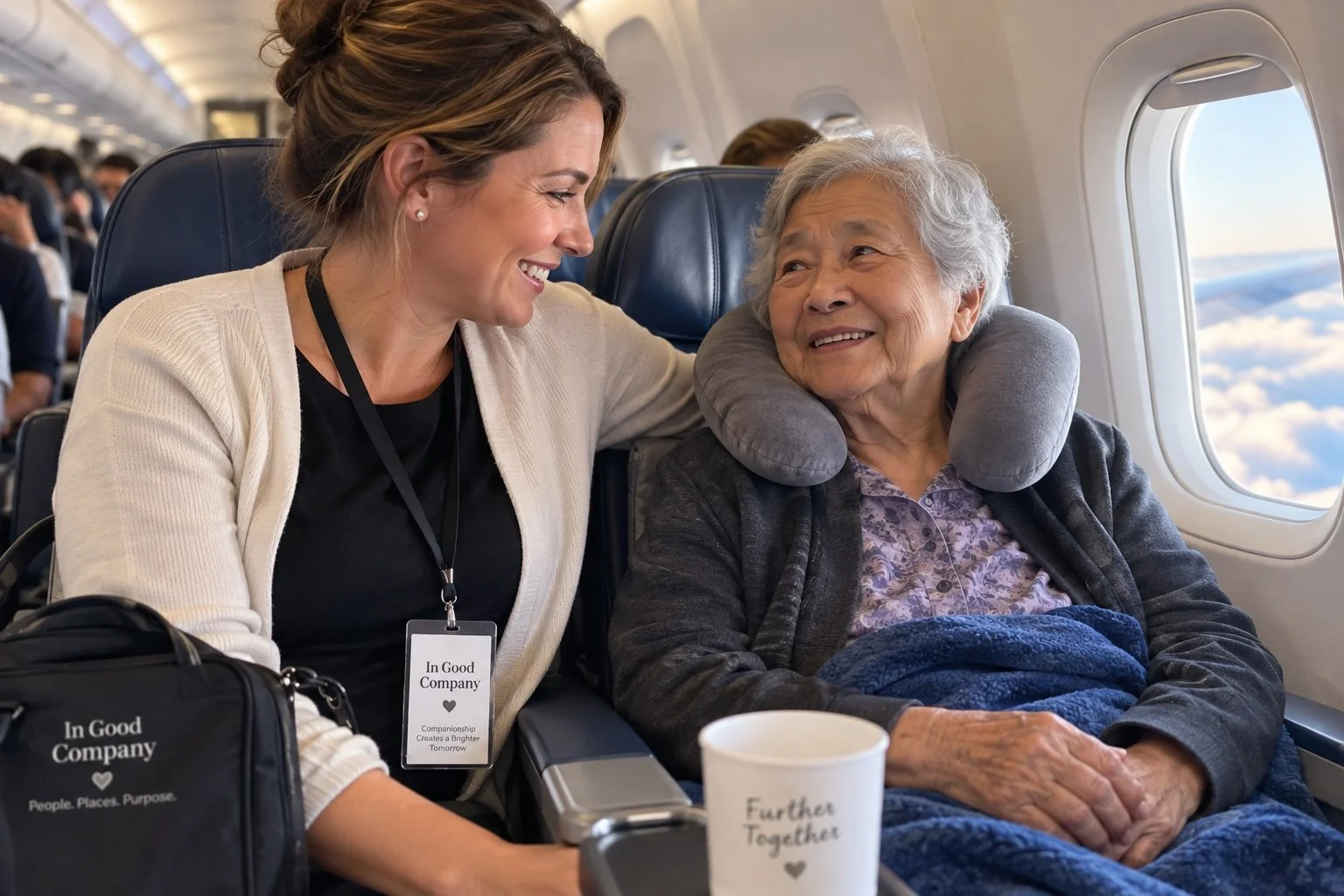 Path to Purpose. An airline passenger sitting next to an elderly woman with a neck pillow, smiling and talking on an airplane.