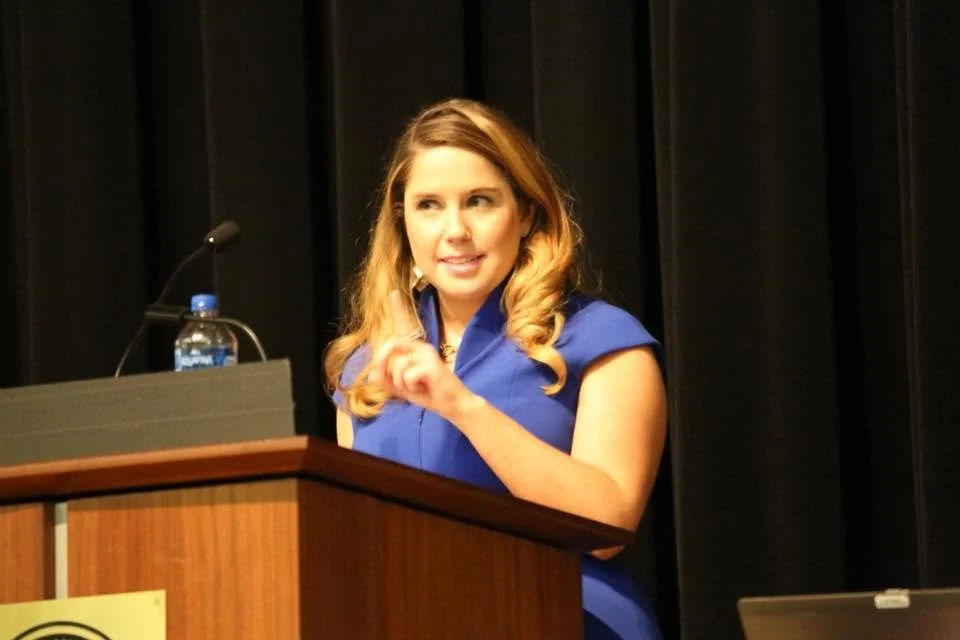 Jenny Ann Urban speaking at a podium on transportation matters.