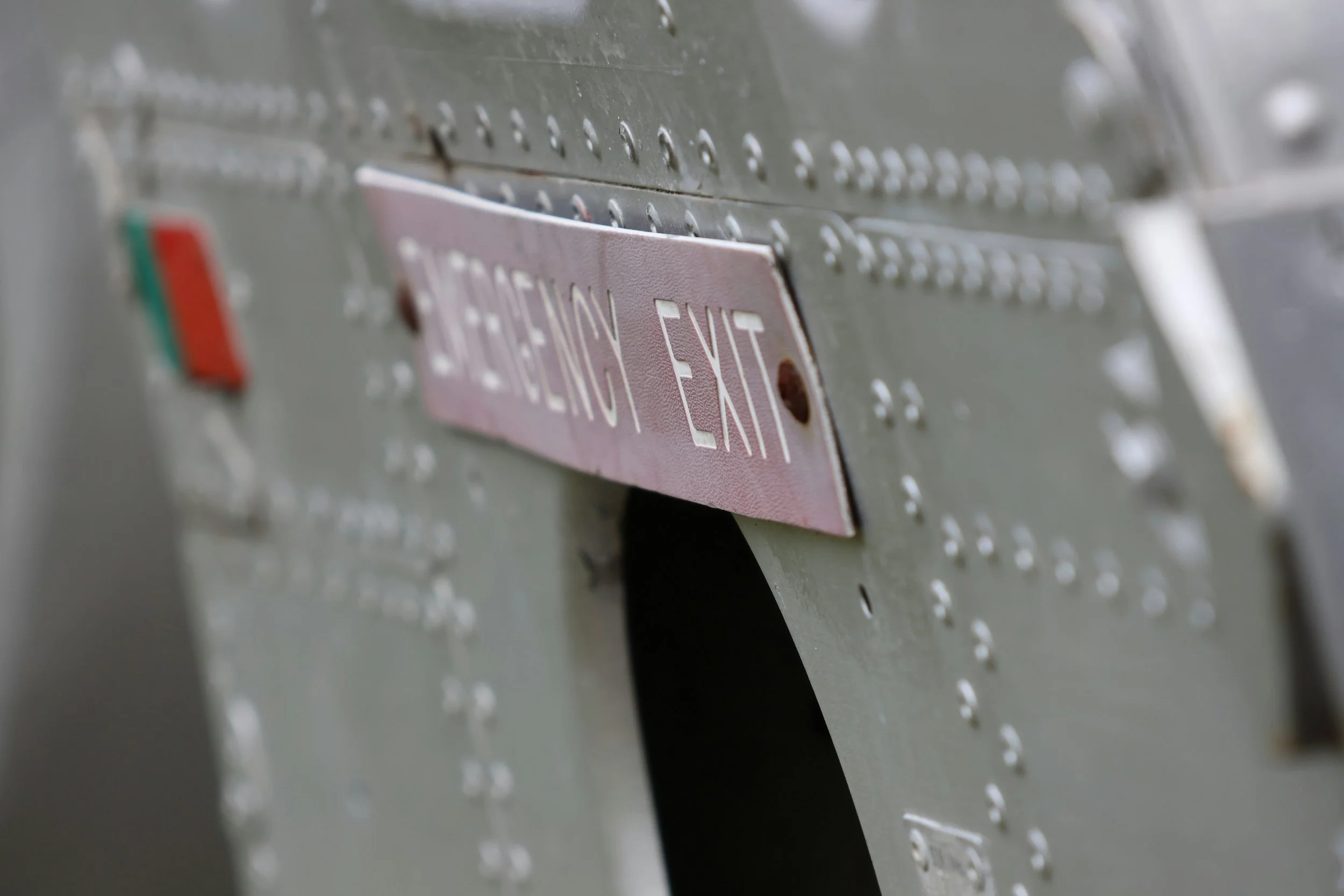 Aircraft emergency exit panel, representing aviation safety and security management systems advisory, including implementation and auditing.
