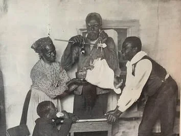 Historical Black and White Photograph of Family Weighing a Baby with Hanging Scale