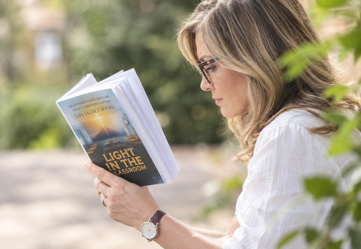 Picture of a woman holding Light in the classroom book