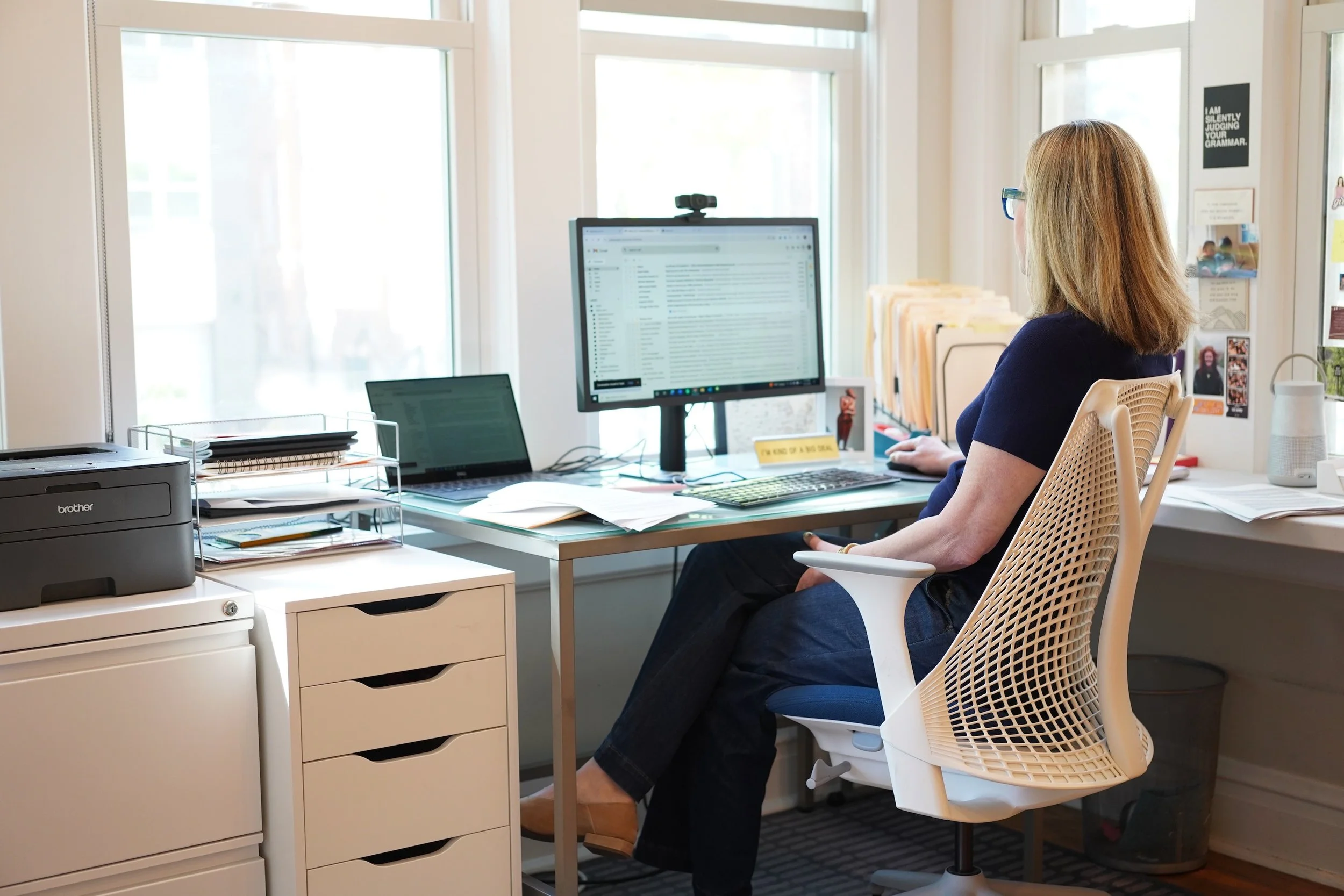 Laurie at desk with computer screen