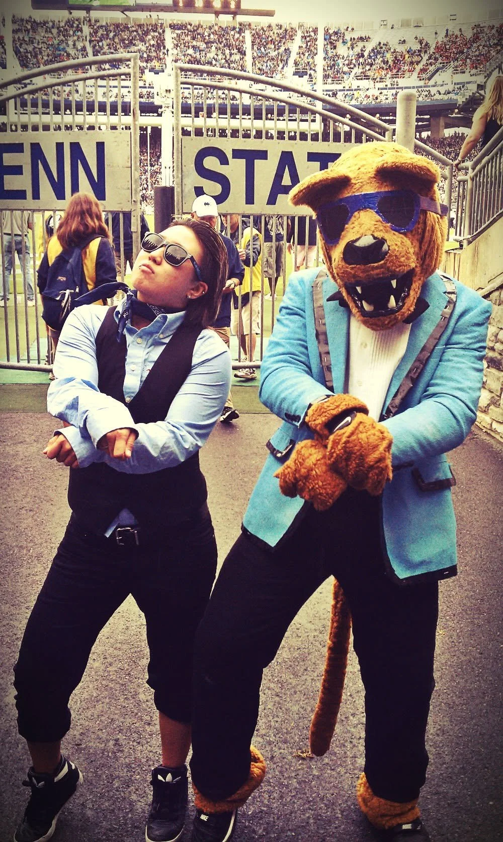Jiggy Yoon posing with the Penn State Nittany Lion mascot at a football stadium