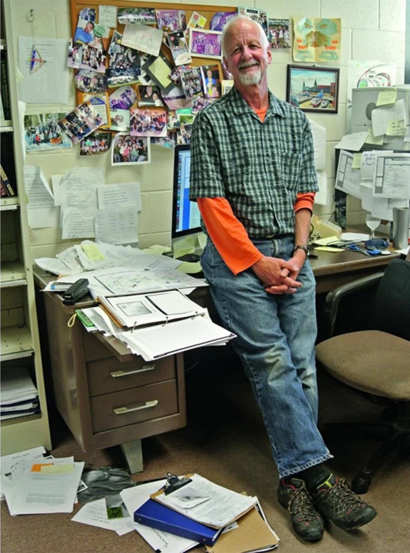 Dr. Christopher Uhl smiling inside his Penn State office