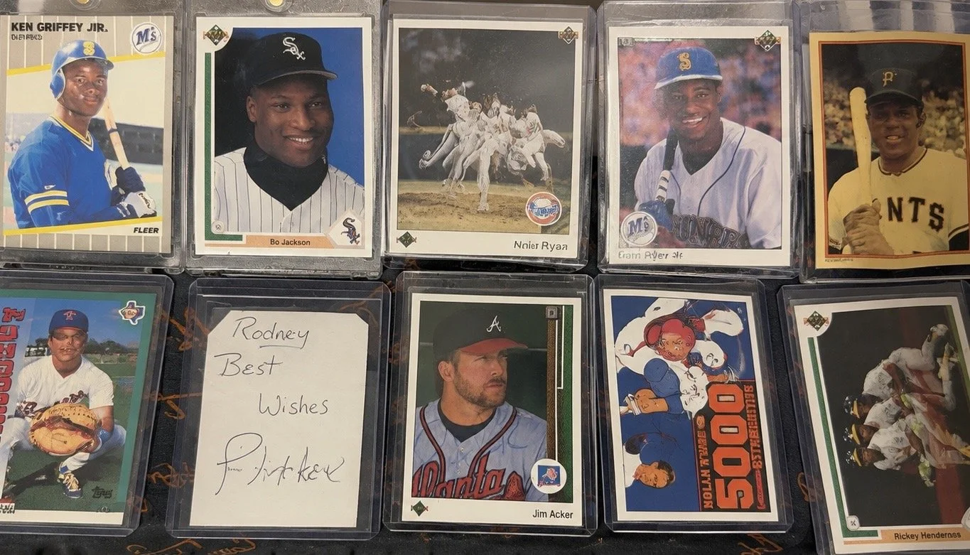 Vintage sports cards in protective holders with a handwritten collector note.