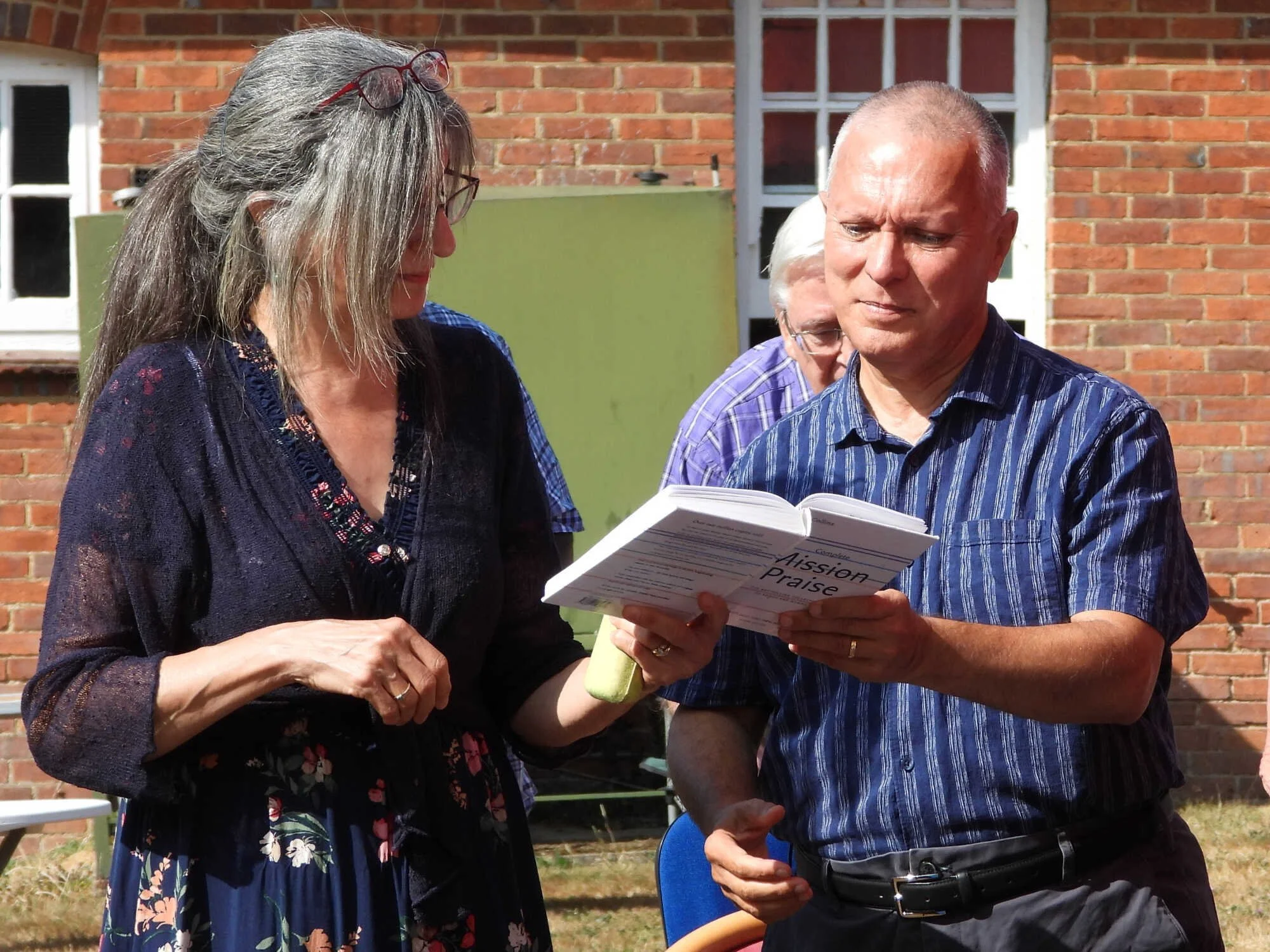 Emmanuel Fellowship members singing together at an outdoor gathering