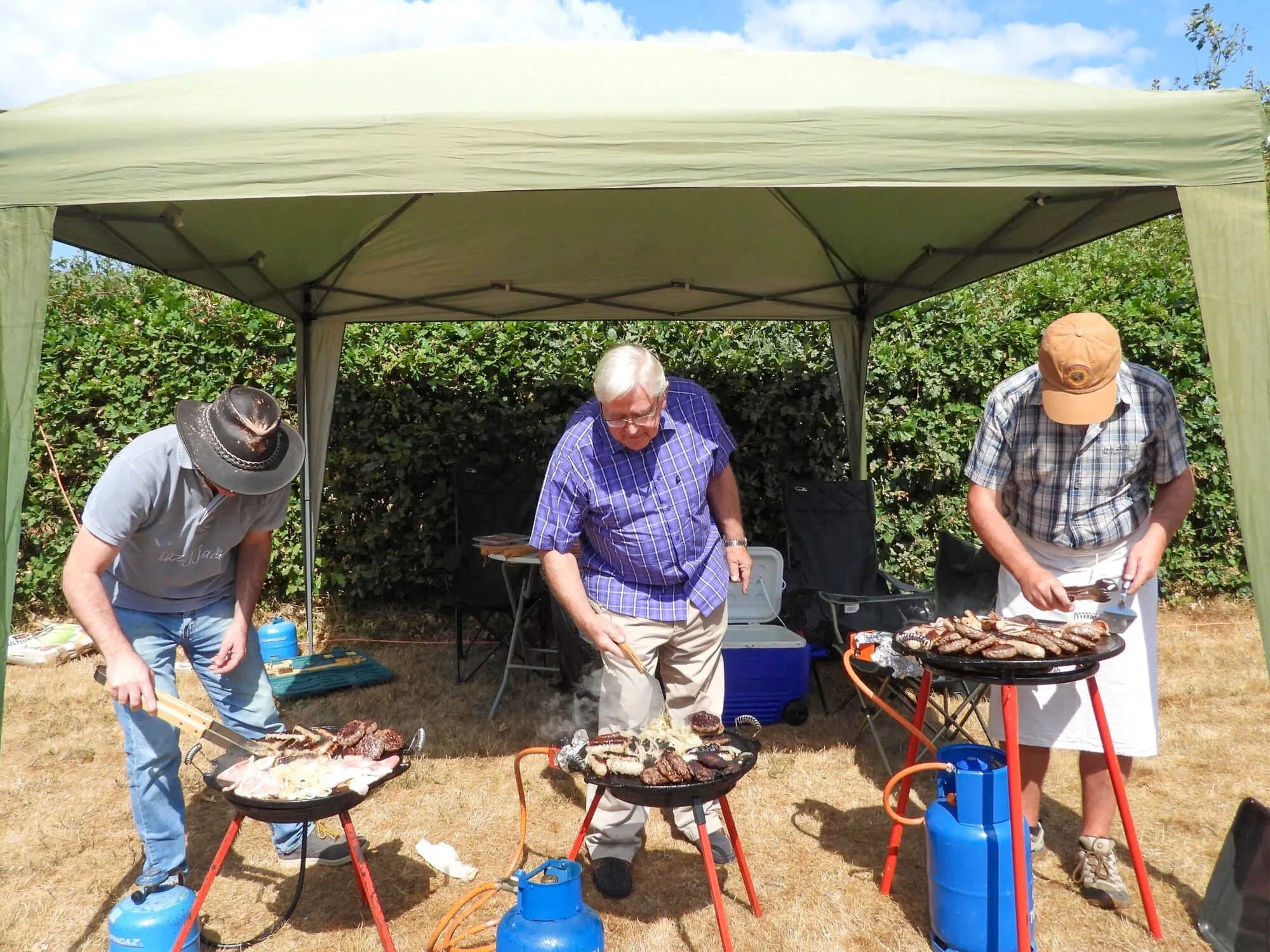 Members of Emmanuel Fellowship preparing food at a summer barbecue