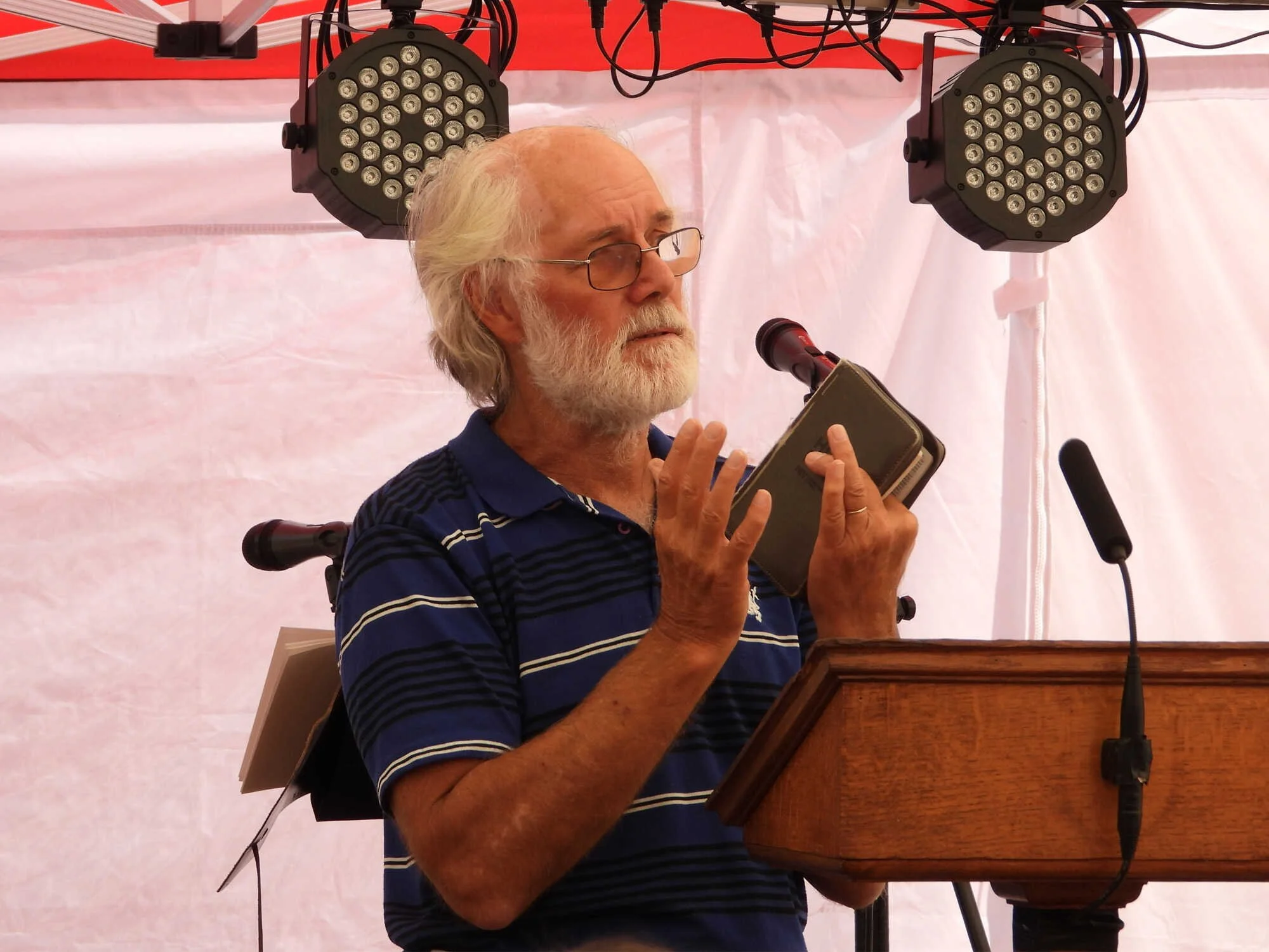 Emmanuel Fellowship member speaking from the lectern during an outdoor service