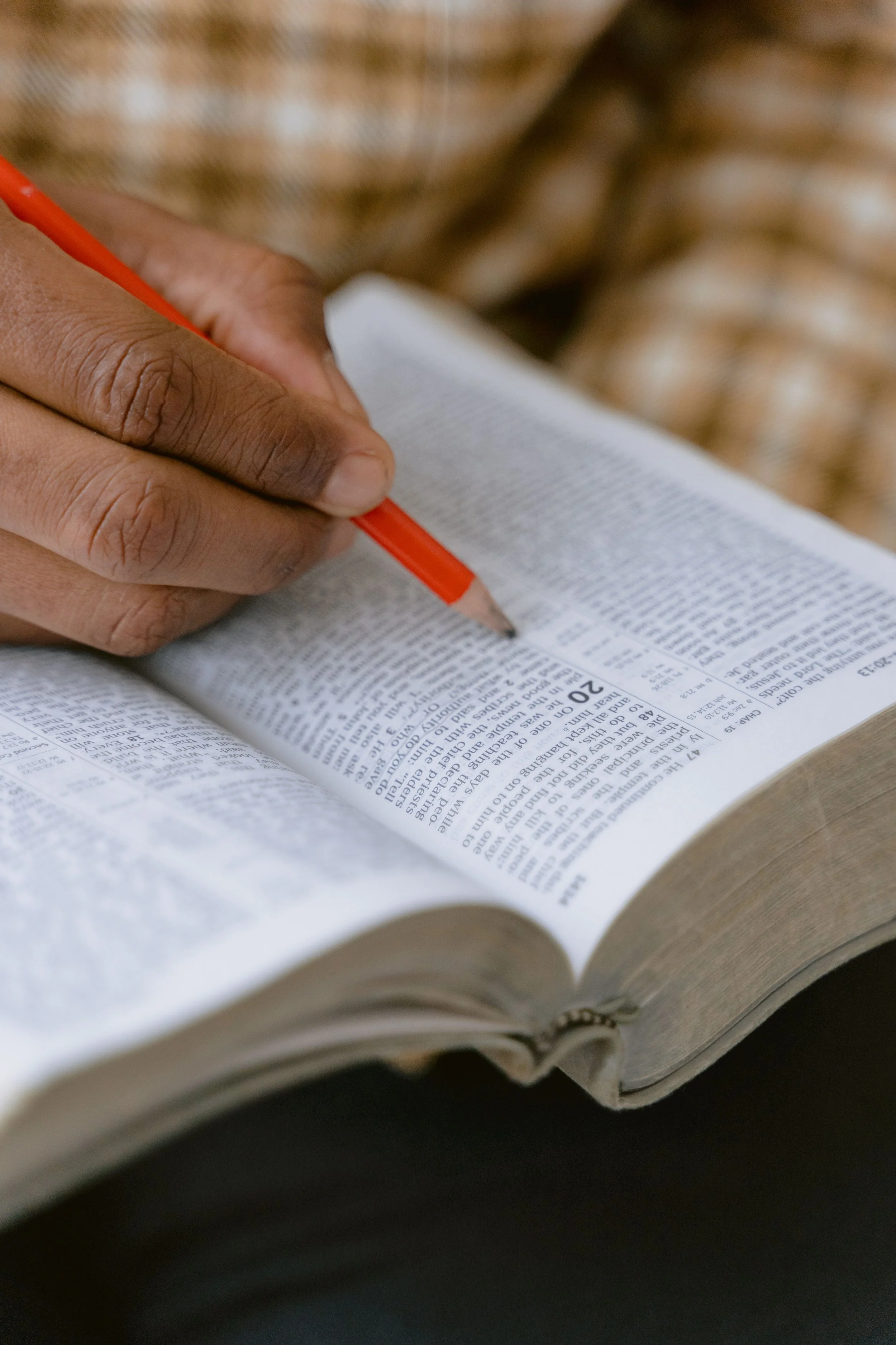 Person holding an open Bible during a church gathering.