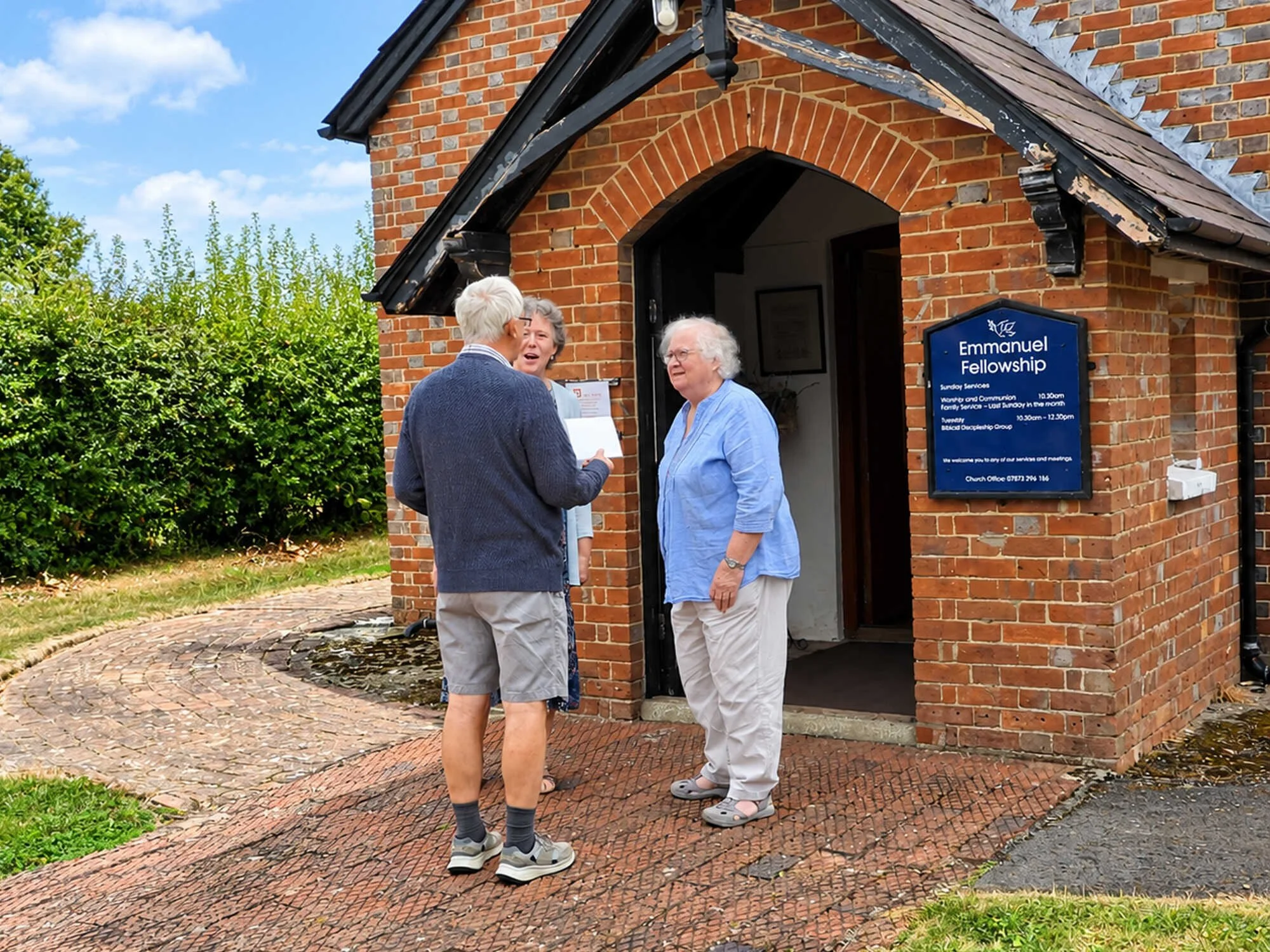 Members of Emmanuel Fellowship talking outside the chapel in Loxwood