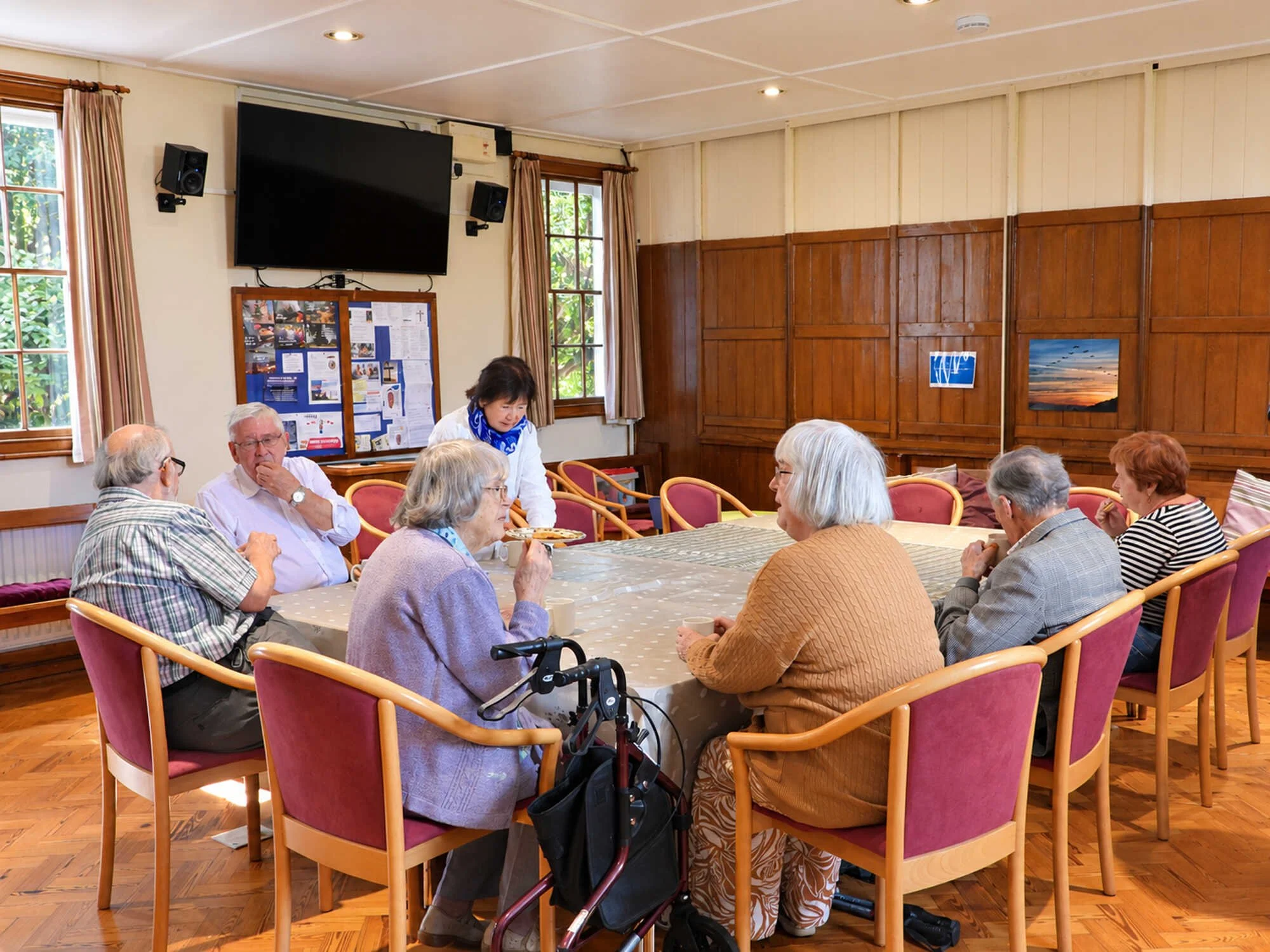 Members of Emmanuel Fellowship gathered around tables for fellowship in Loxwood