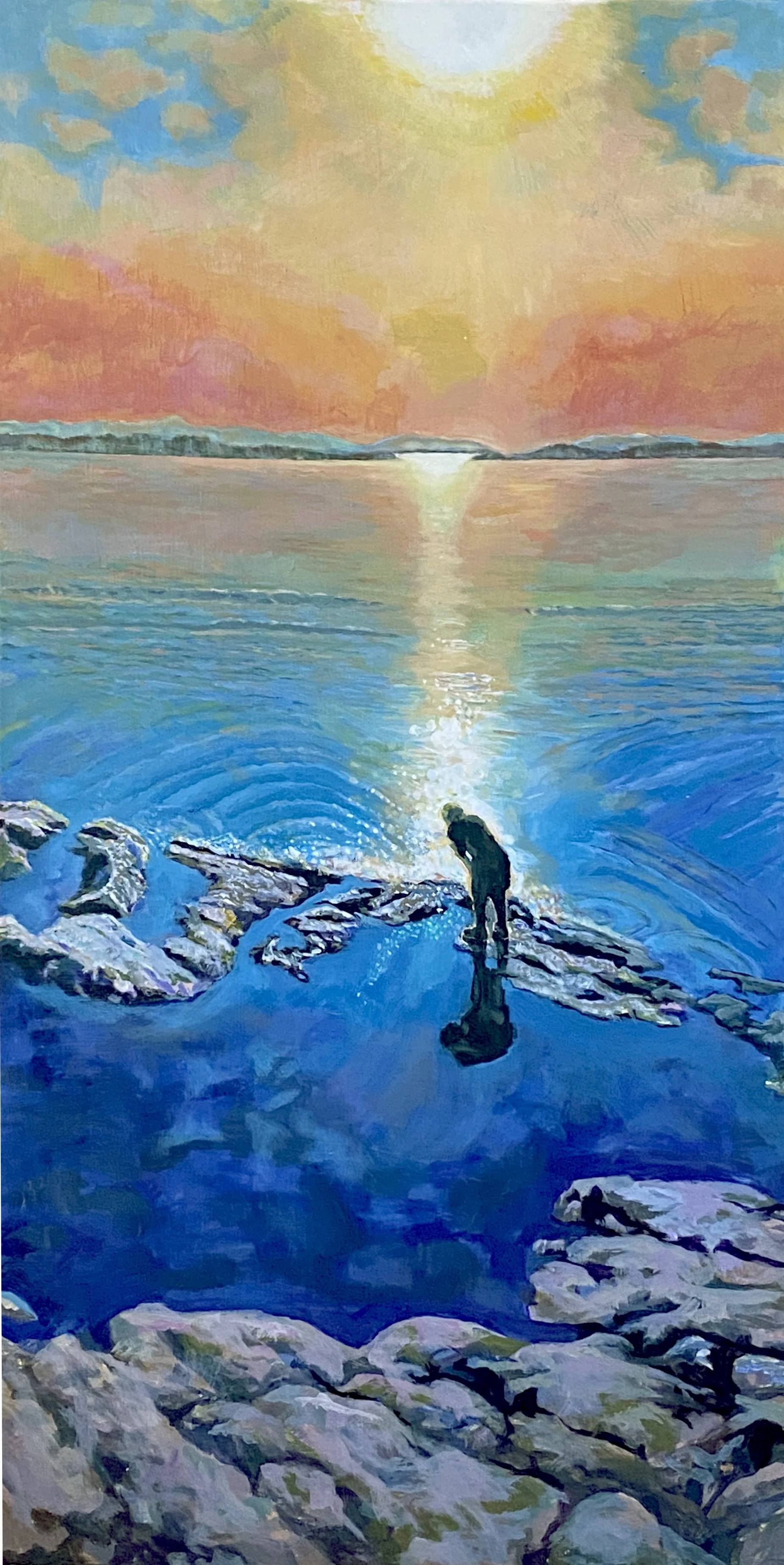 Sunrise shining over Discovery Island with young boy in foreground bending over an interest in the water ,sunlight travels across water to surround boy with bright light , Rocky foregroud sunset on the water, Victoria BC,