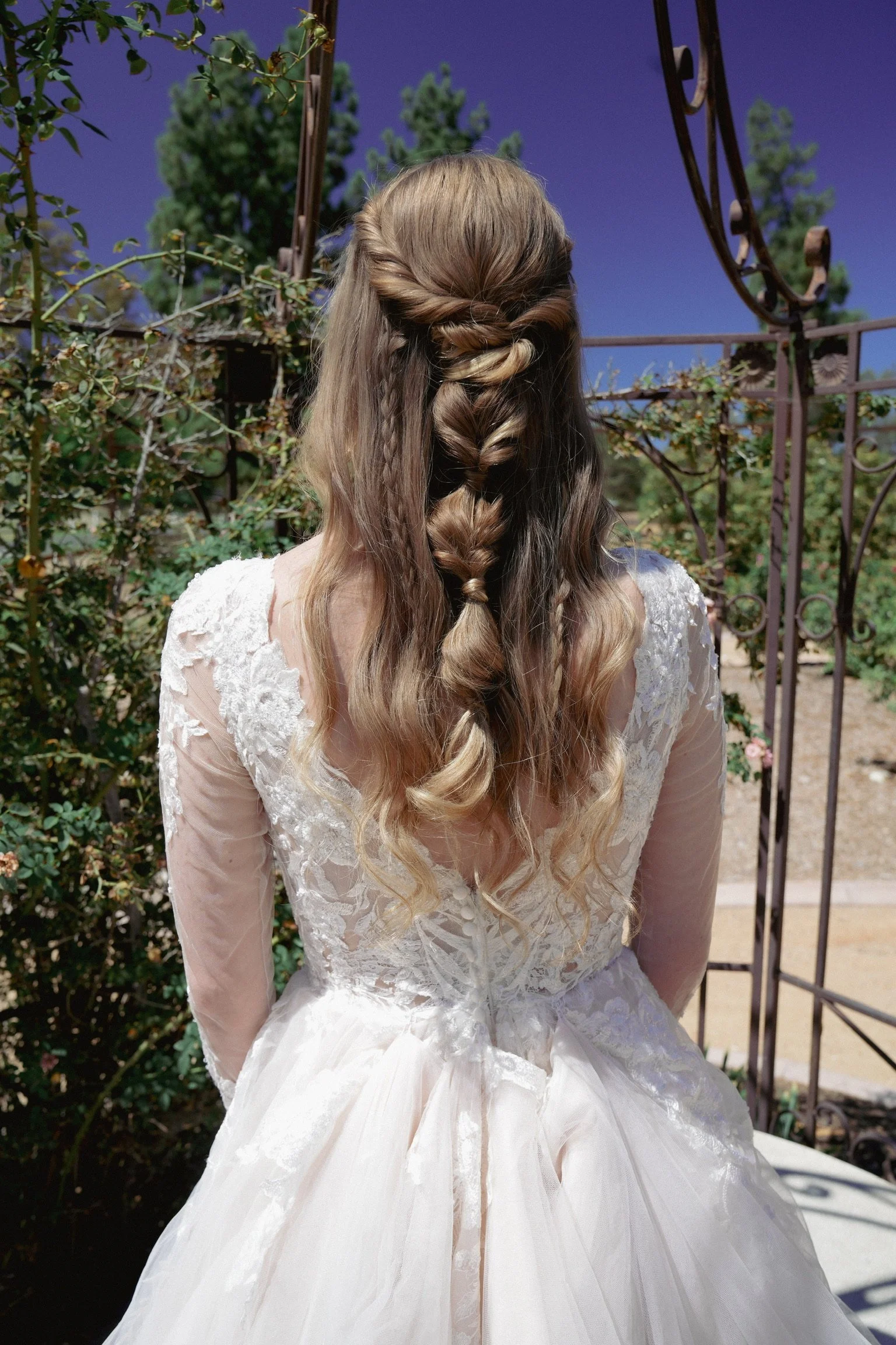 Temecula Bride with a half up half down boho braided hair style.