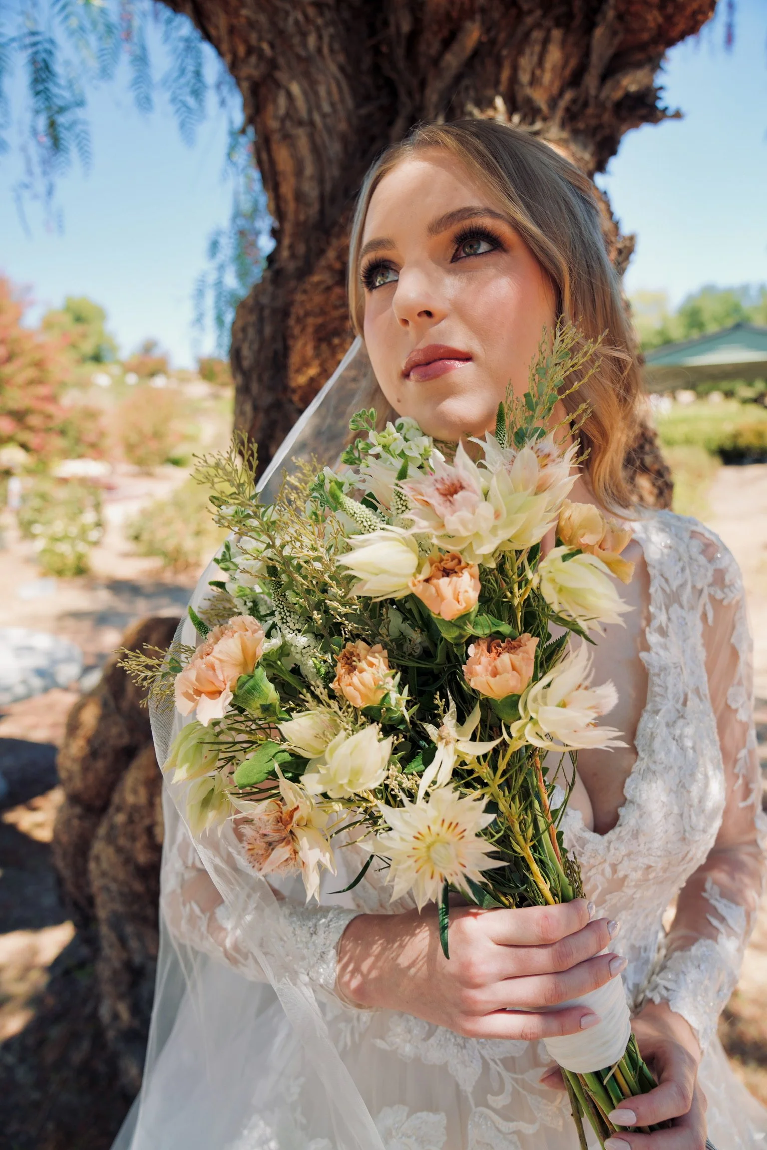 Bridal Portrait in Temecula showcasing her makeup by Til Death Beauty co in a rose garden.