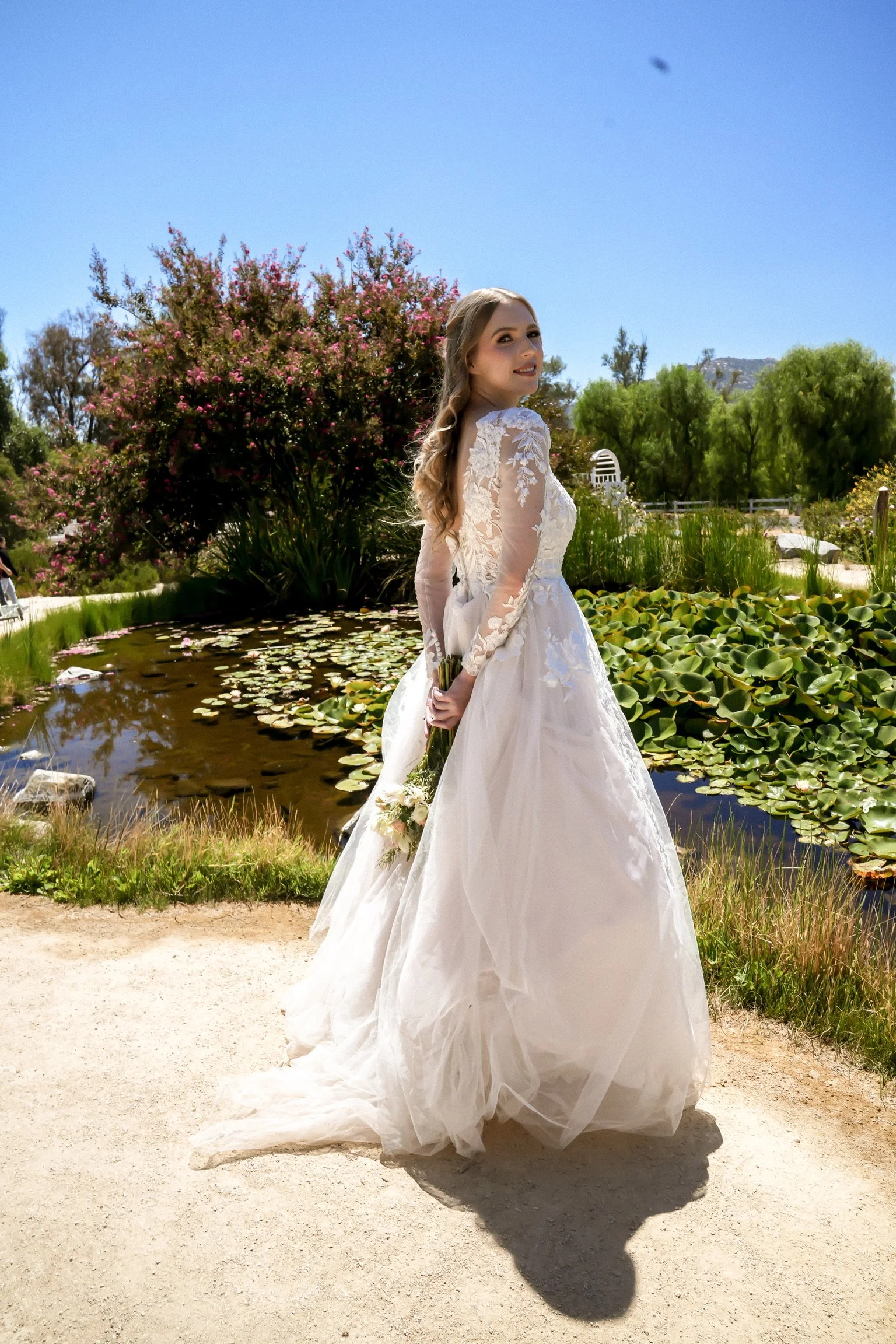 Bridal Portrait posing in front of lily pad pond in Temecula, hair and makeup by Til Death Beauty Co.