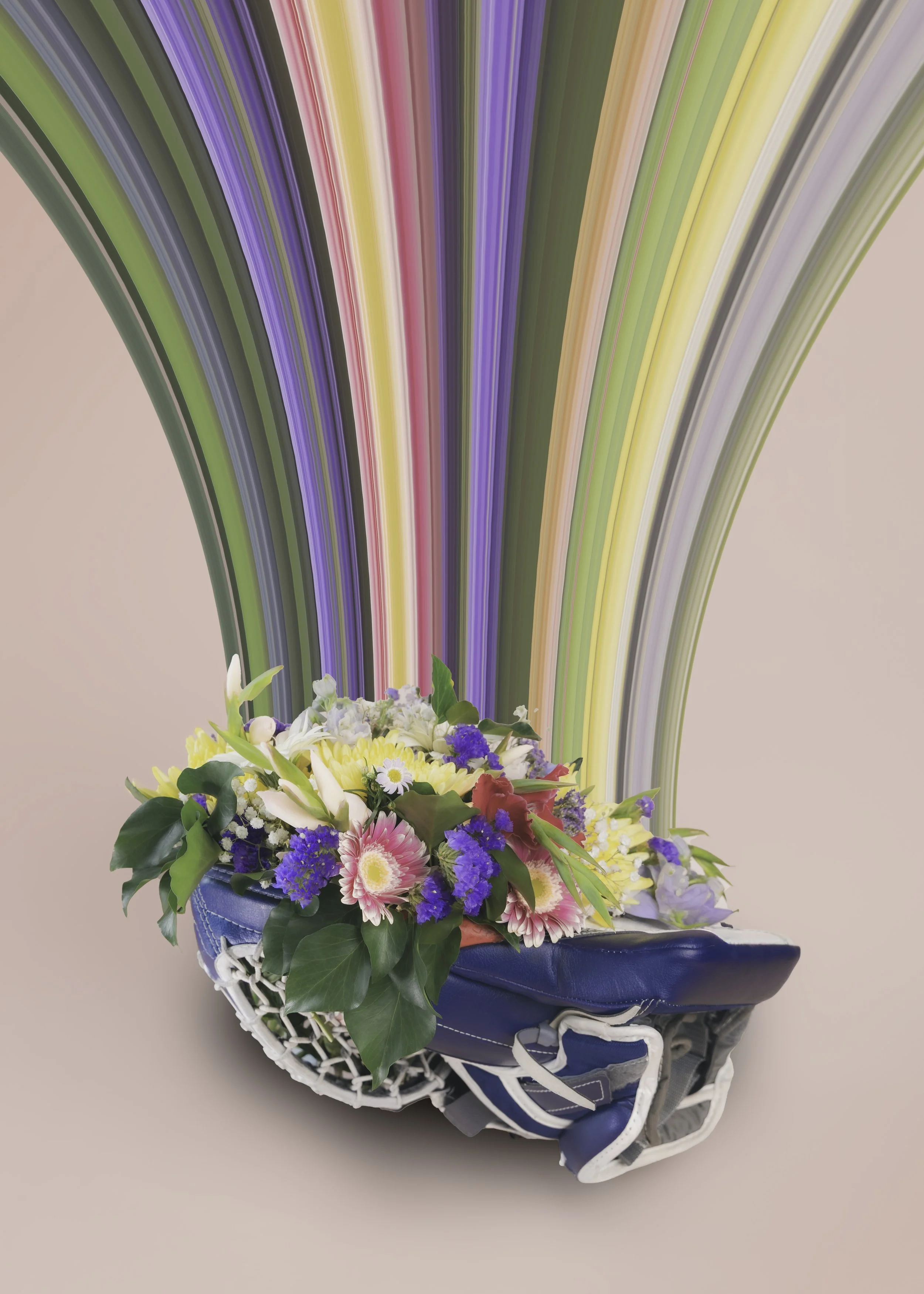 A bouquet of colorful flowers in a hockey goalie glove, with a multicolored ribbon decoration behind it.