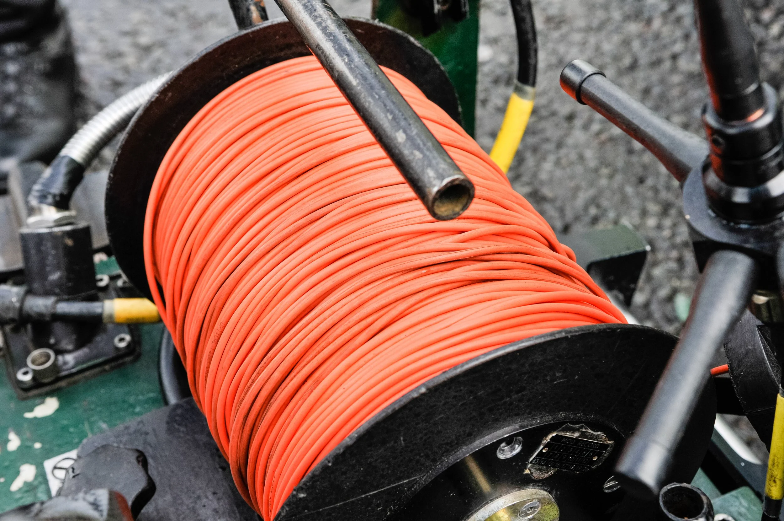 Close-up of a spool of orange cord.