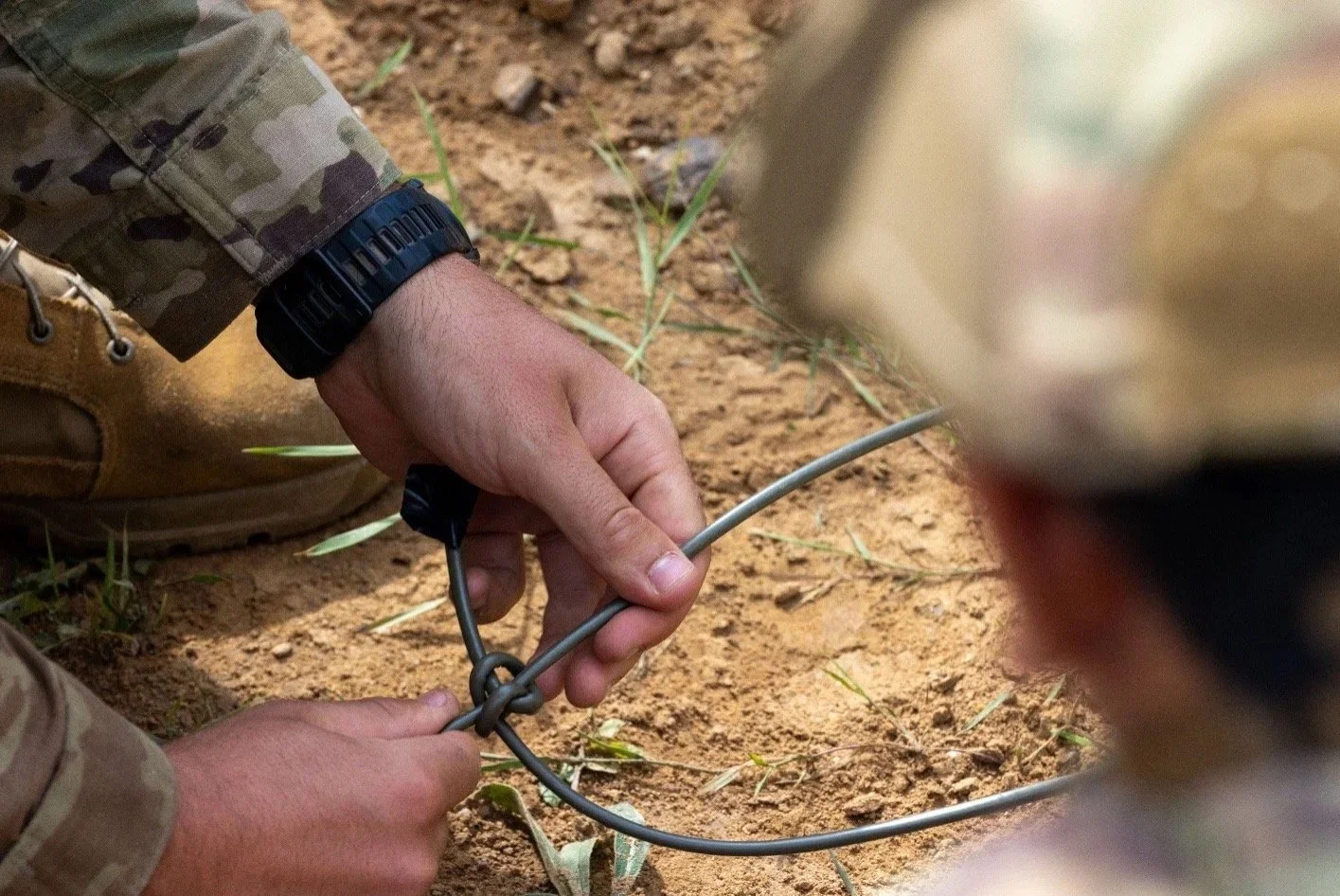 A person in military uniform holding a cord.