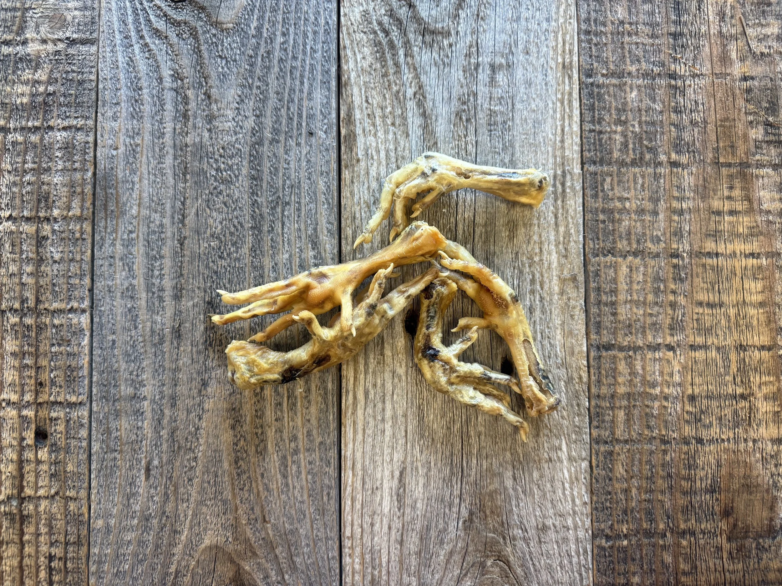 Dried chicken feet on a rustic wooden table