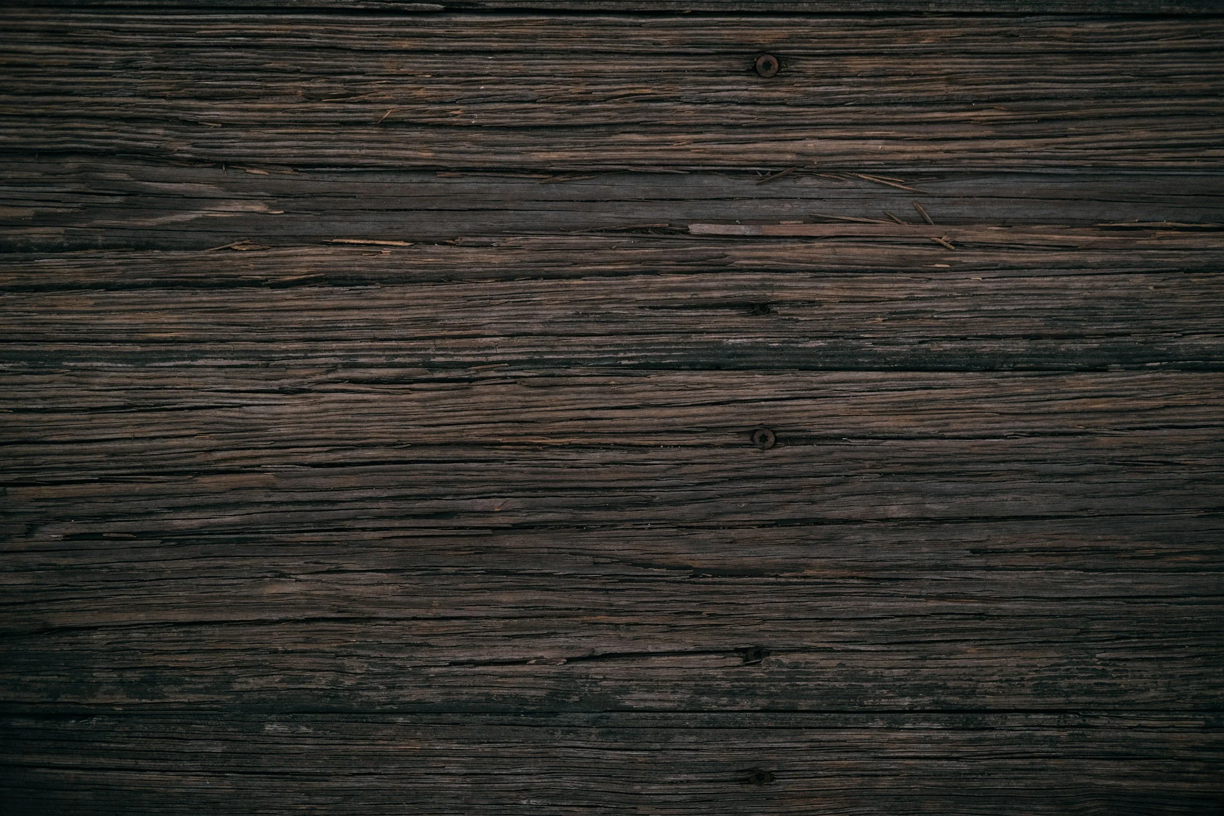 Close-up view of weathered wooden planks with visible grain and texture.