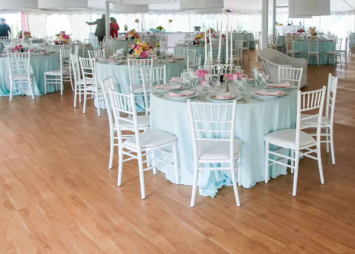 Elegant banquet hall decorated with round tables covered in light blue tablecloths, for a formal event in Baltimore and DC metro area