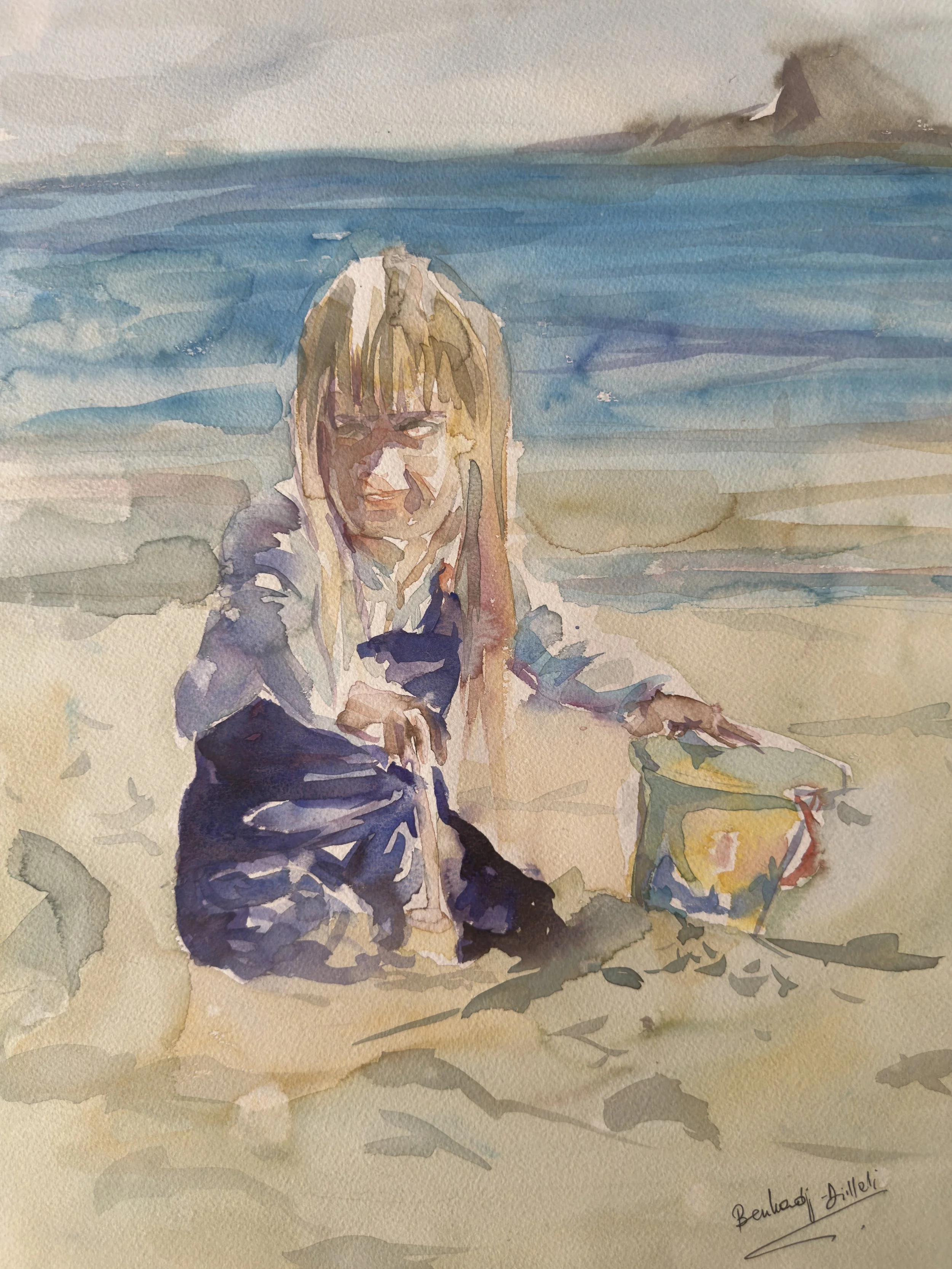 A watercolor painting of a woman sitting on a beach, with blue water and distant mountains in the background.