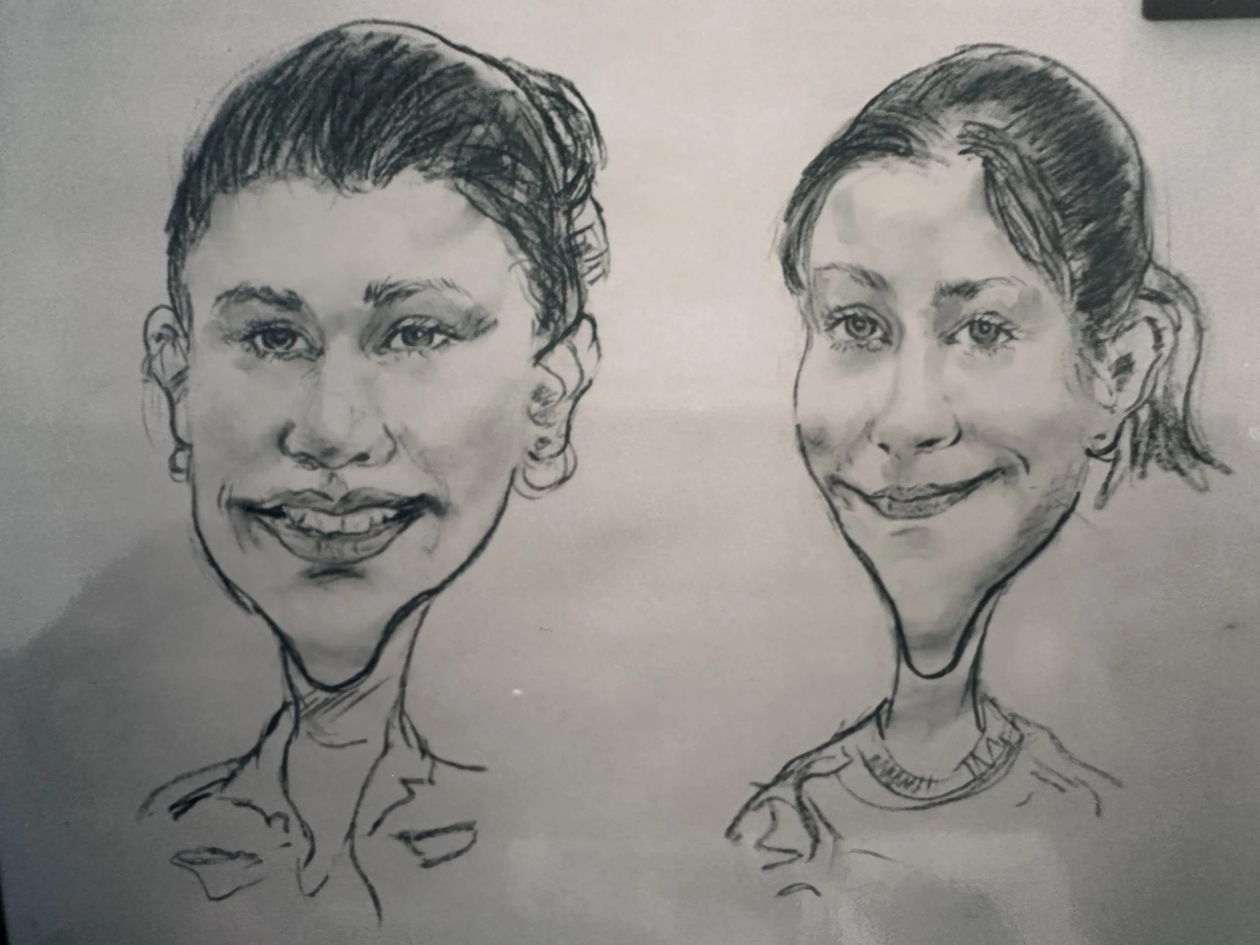 A black and white sketch of two women with short and styled hair, smiling.