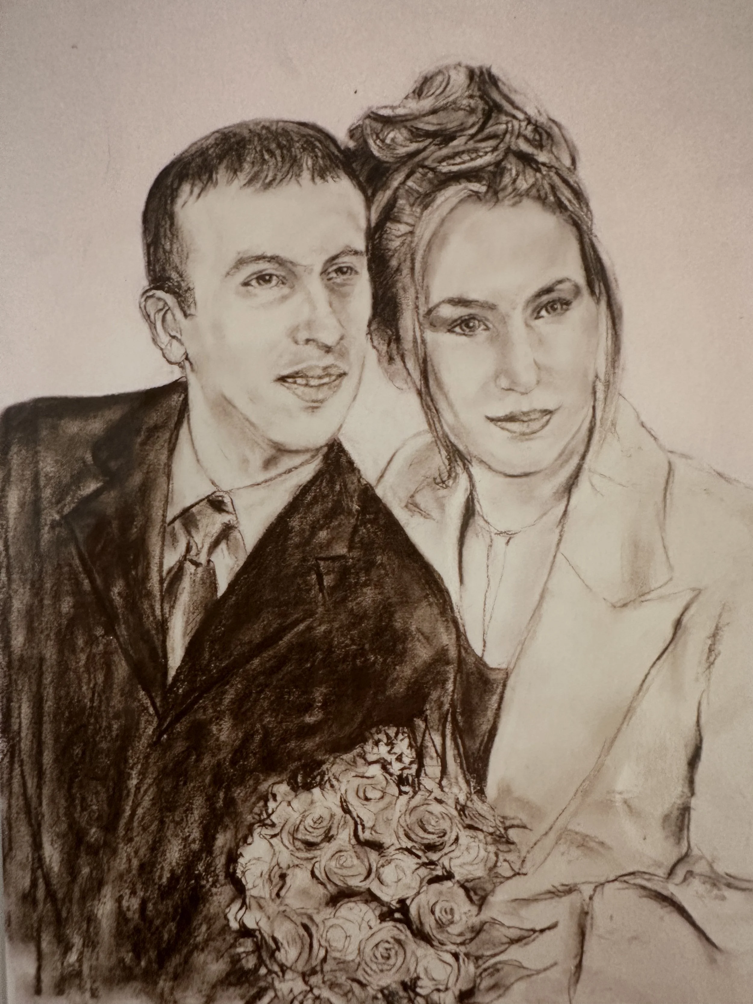 A pencil sketch of a man and a woman sitting closely together. The man has short hair and is wearing a collared shirt and jacket. The woman has her hair styled in an updo and is wearing a blazer. There is a bouquet of roses at their lap.